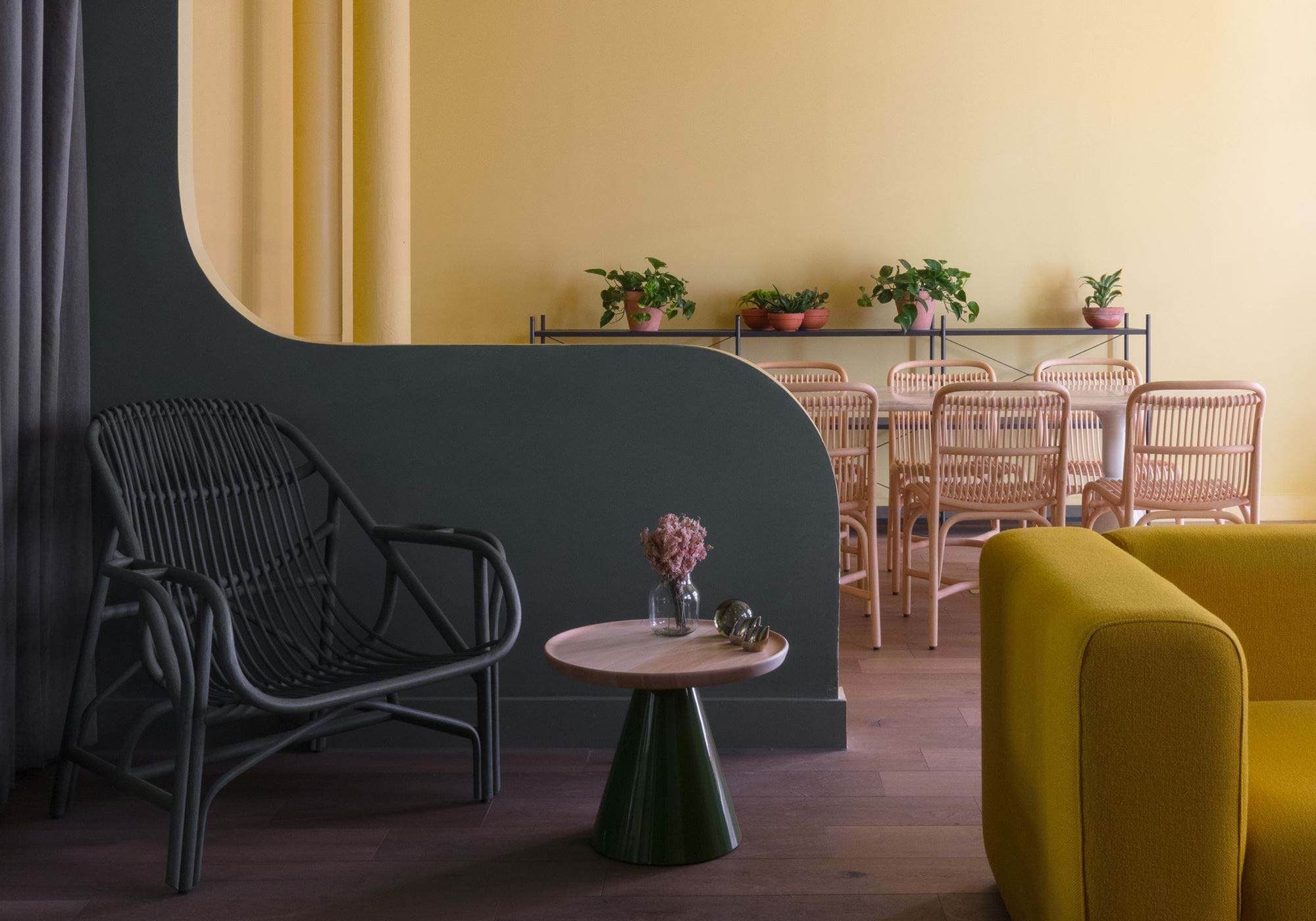 Stylish coworking meeting space with yellow walls, ideal for collaboration and creativity.