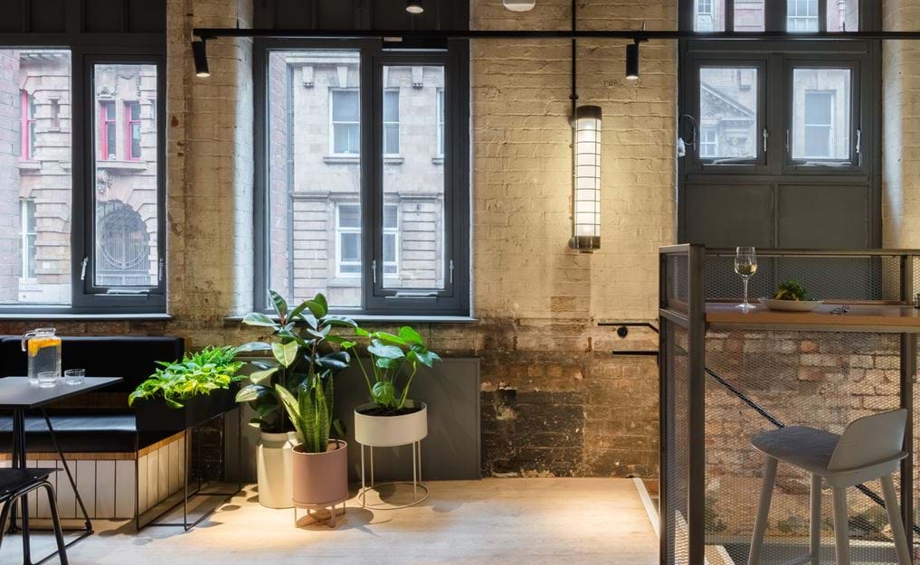 Modern coworking space with large windows, ideal for networking events and meetings.