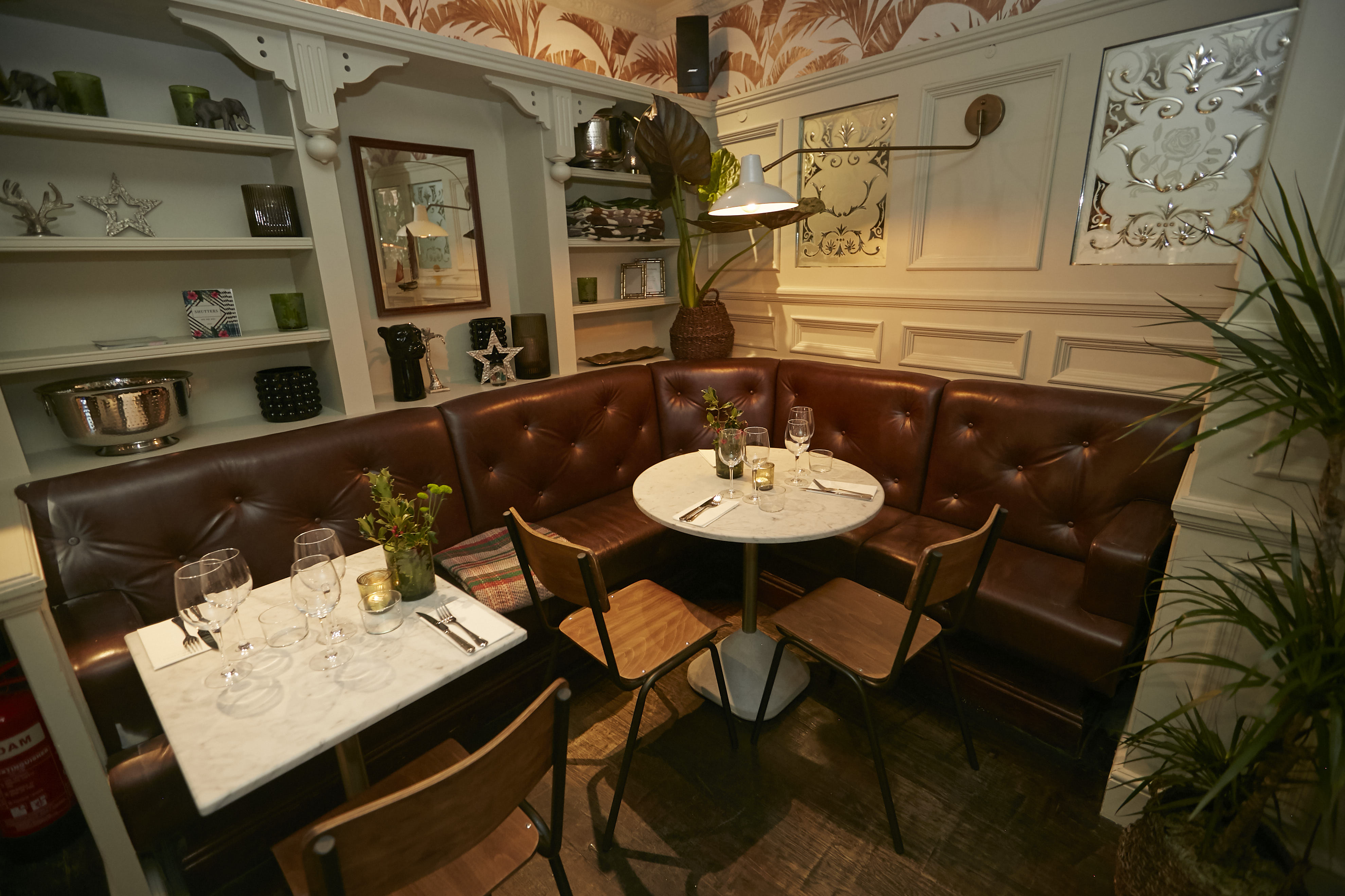 Cozy dining space with plush leather seating for private events and networking lunches.