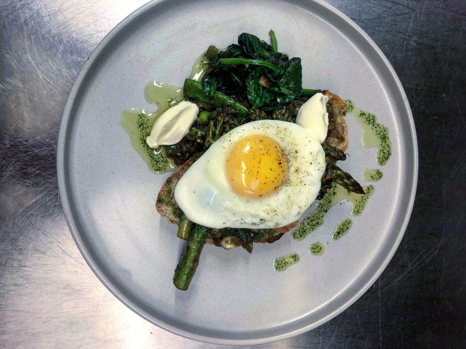 Upscale plated dish with egg and greens at Maddison's Bar & Kitchen event venue.