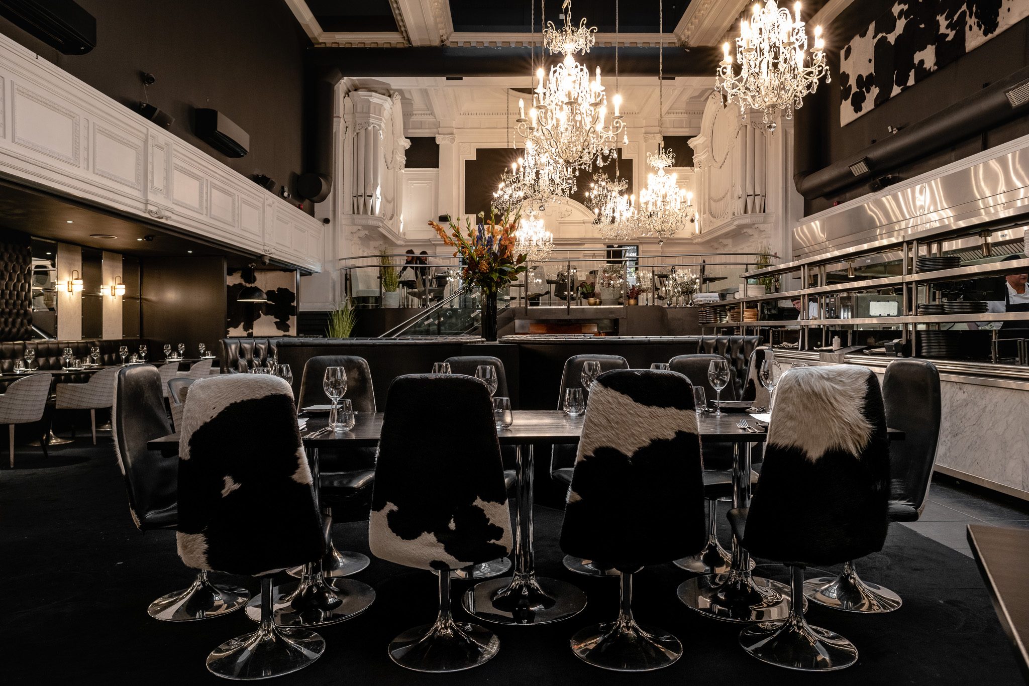 Upscale dining venue in Gaucho Manchester with elegant chandeliers and cowhide chairs.
