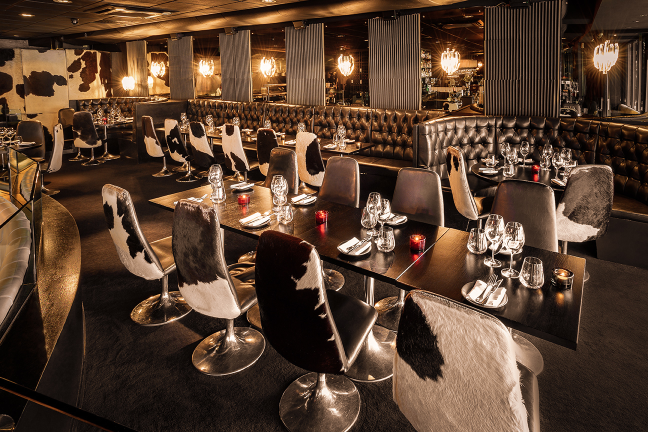 Stylish dining space with cowhide chairs, ideal for upscale events and gatherings.