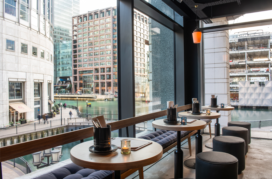 Modern waterfront restaurant lounge with sleek decor, ideal for networking events.