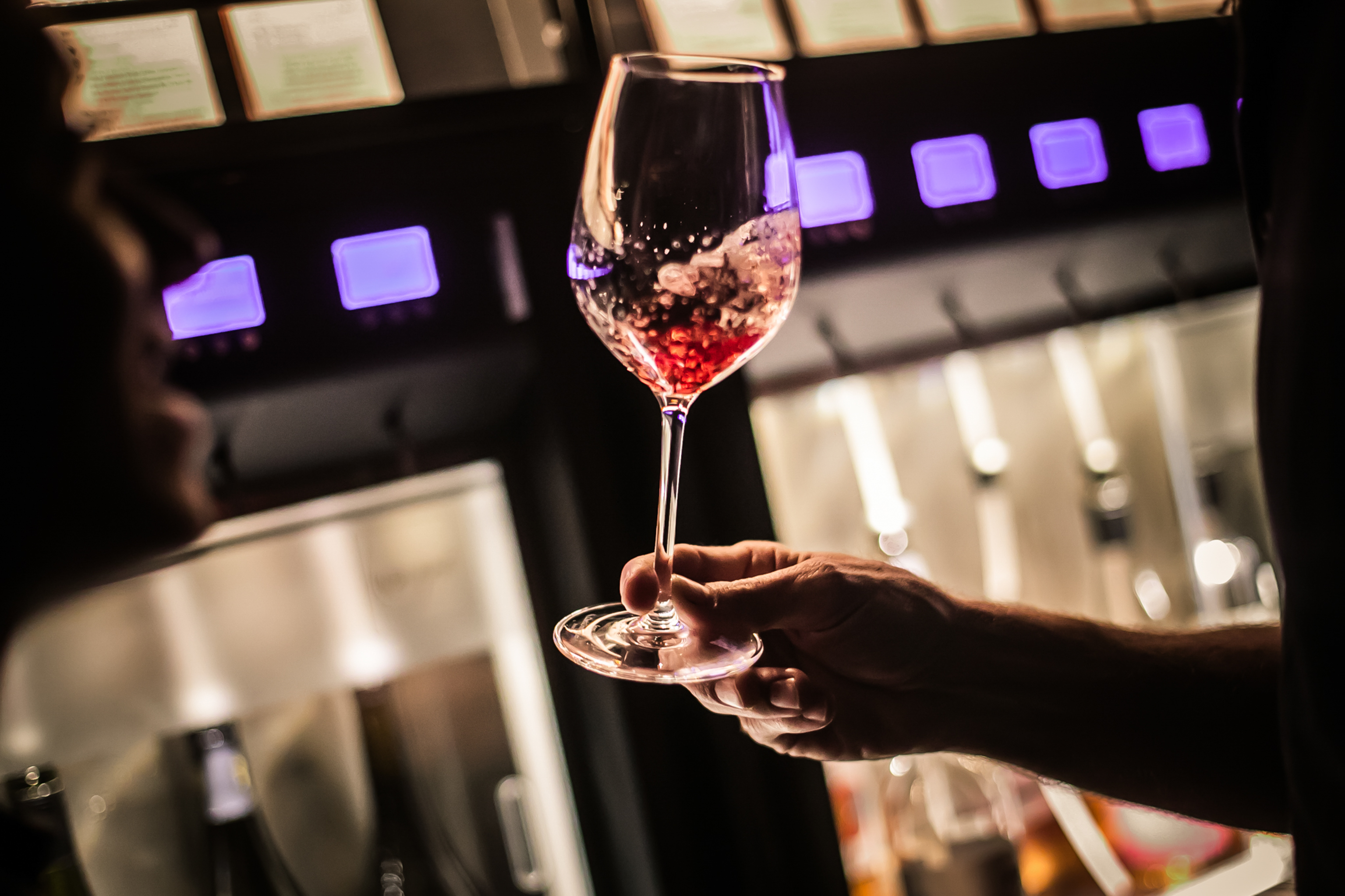 Elegant wine glass in ambient lighting at Vagabond Canary Wharf event. Celebrations, networking.