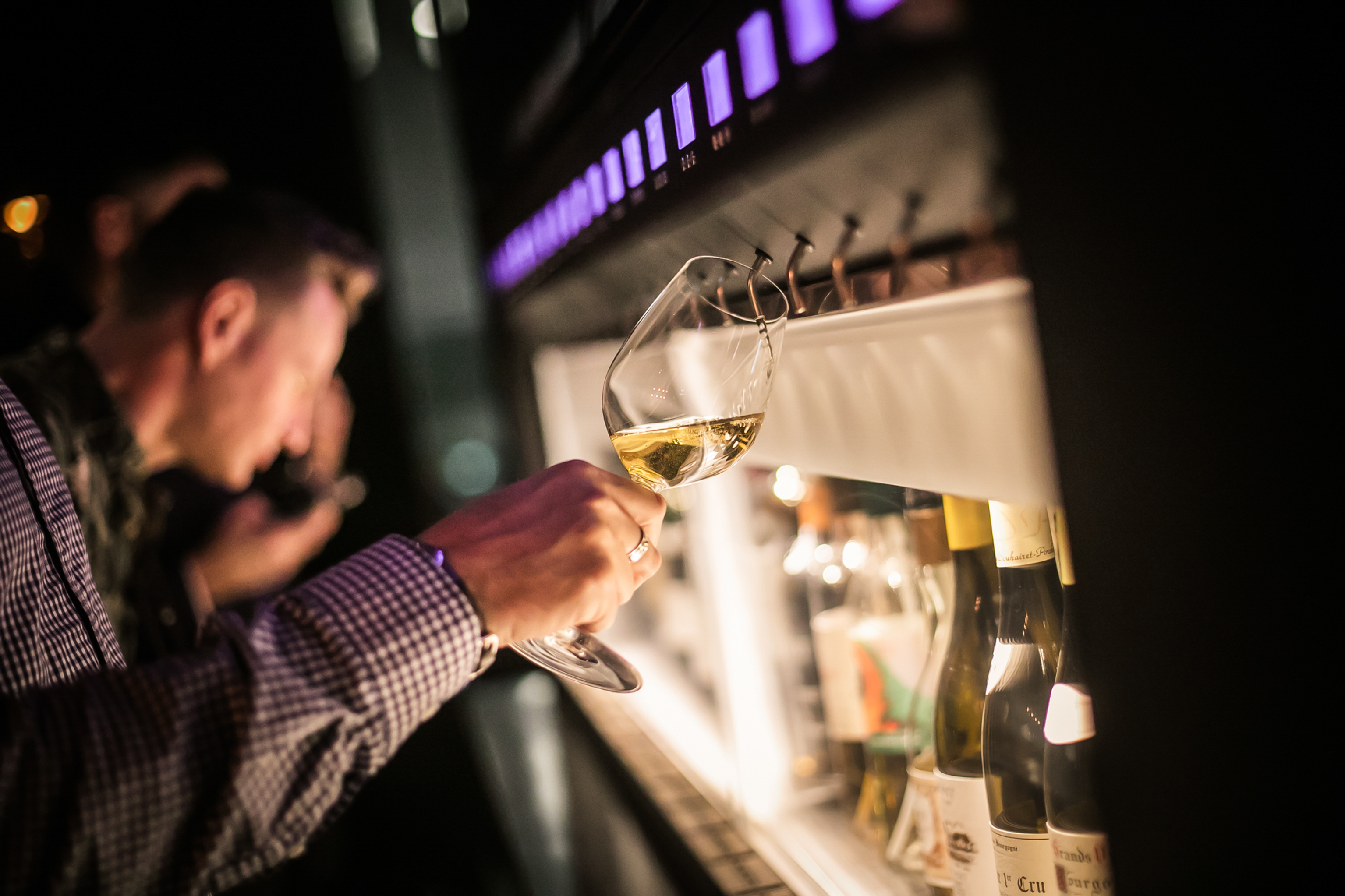 Guest enjoying self-serve wine at a stylish event in Vagabond Canary Wharf.
