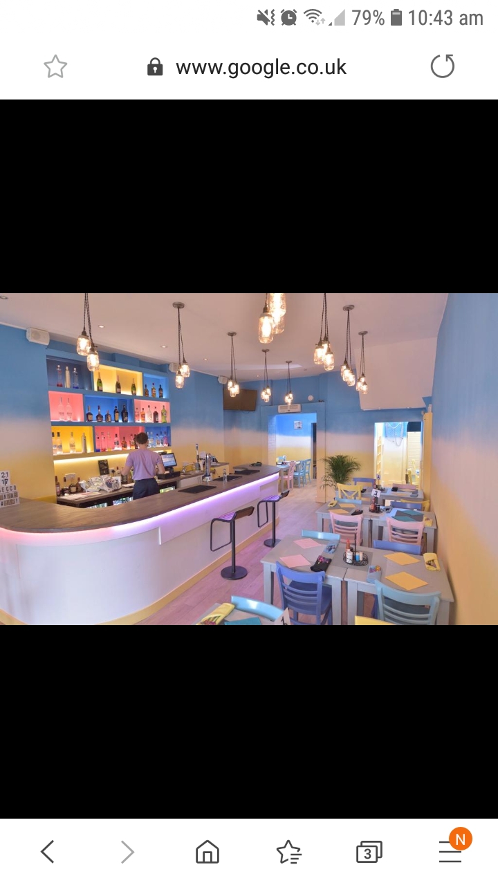 Vibrant modern café venue with colorful decor for casual meetings and events.