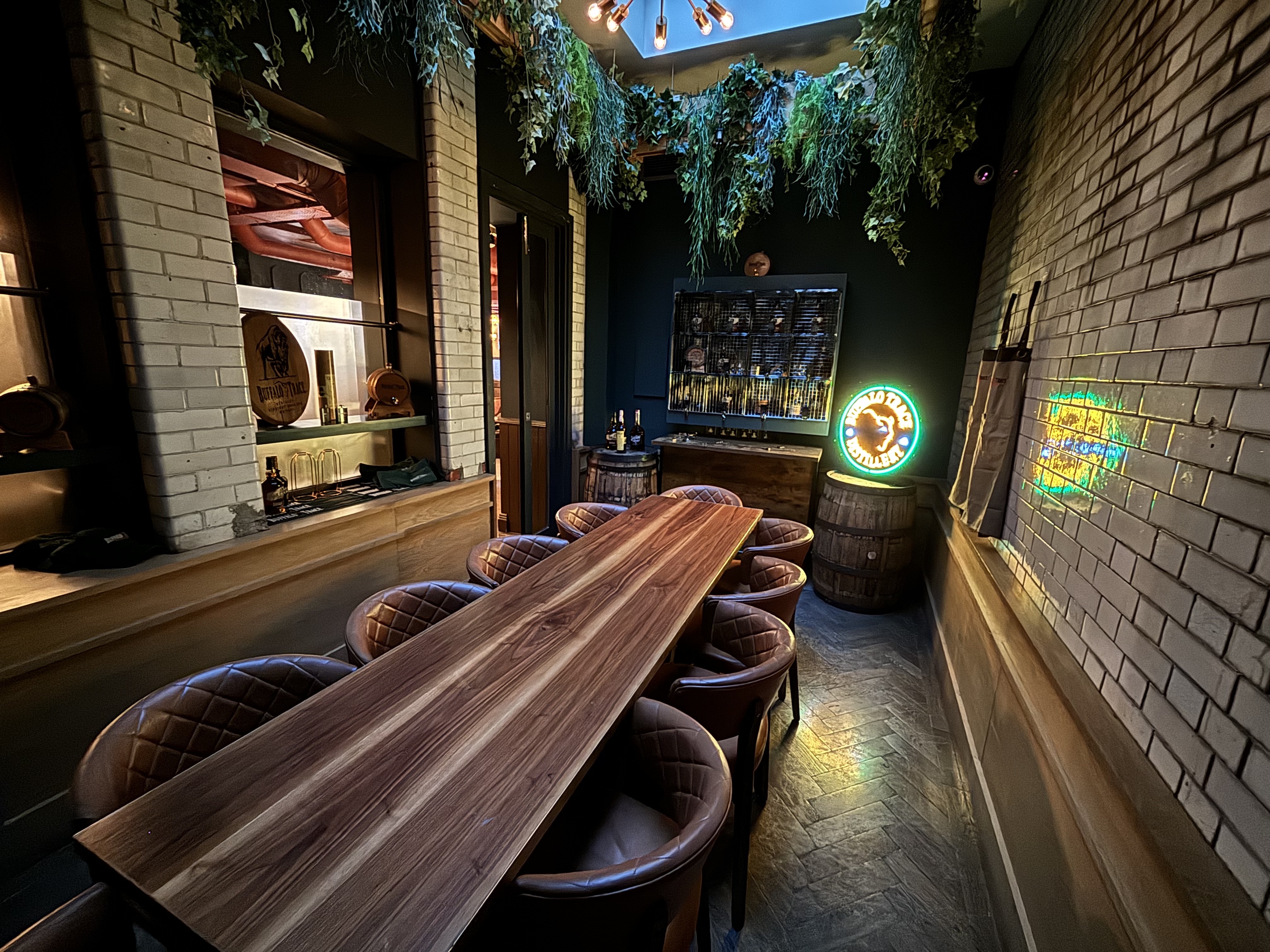 Private dining room at The Wren Tavern with a long wooden table, ideal for meetings and events.