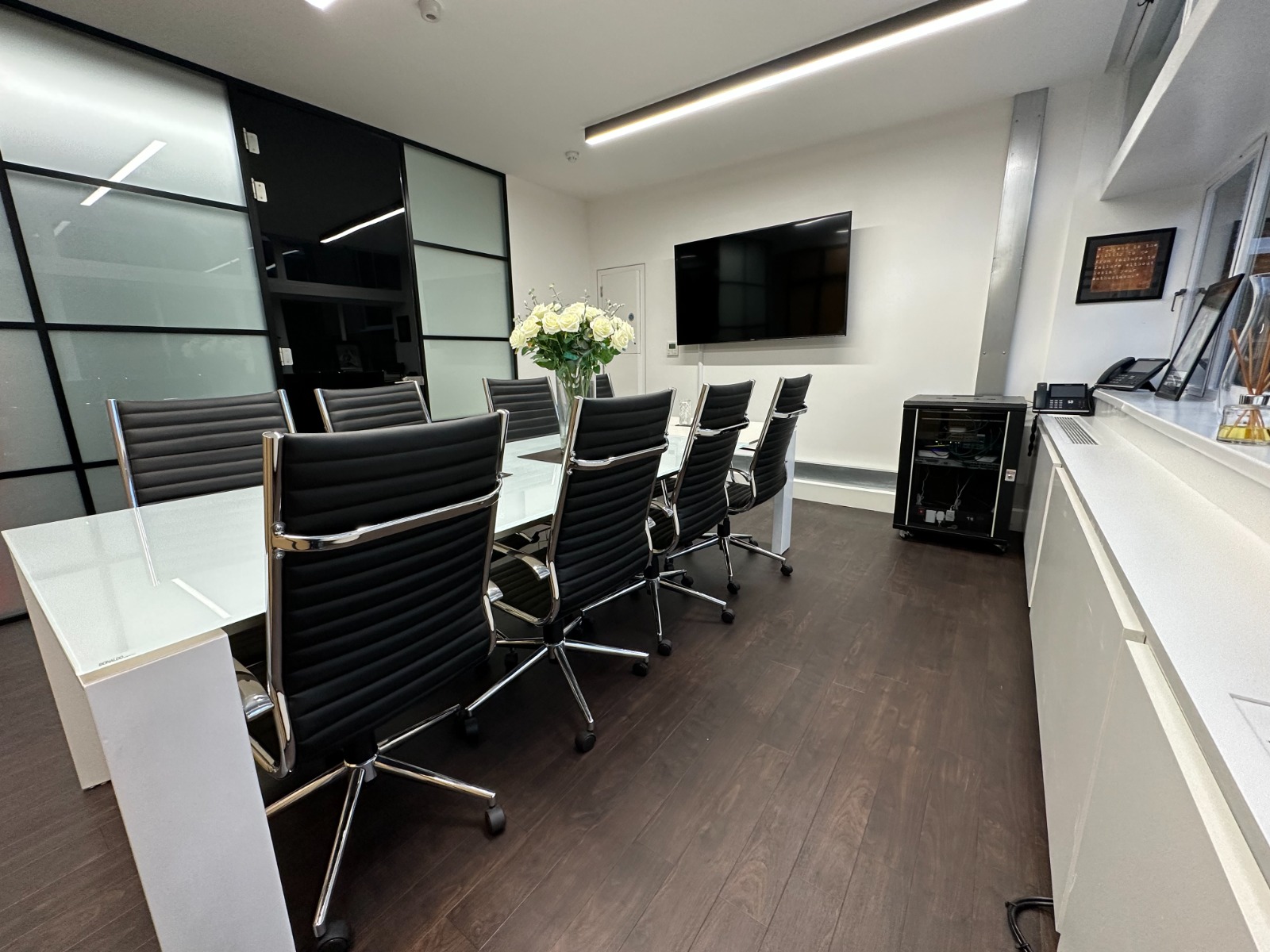 Modern conference room with glass walls, ideal for professional meetings and events.