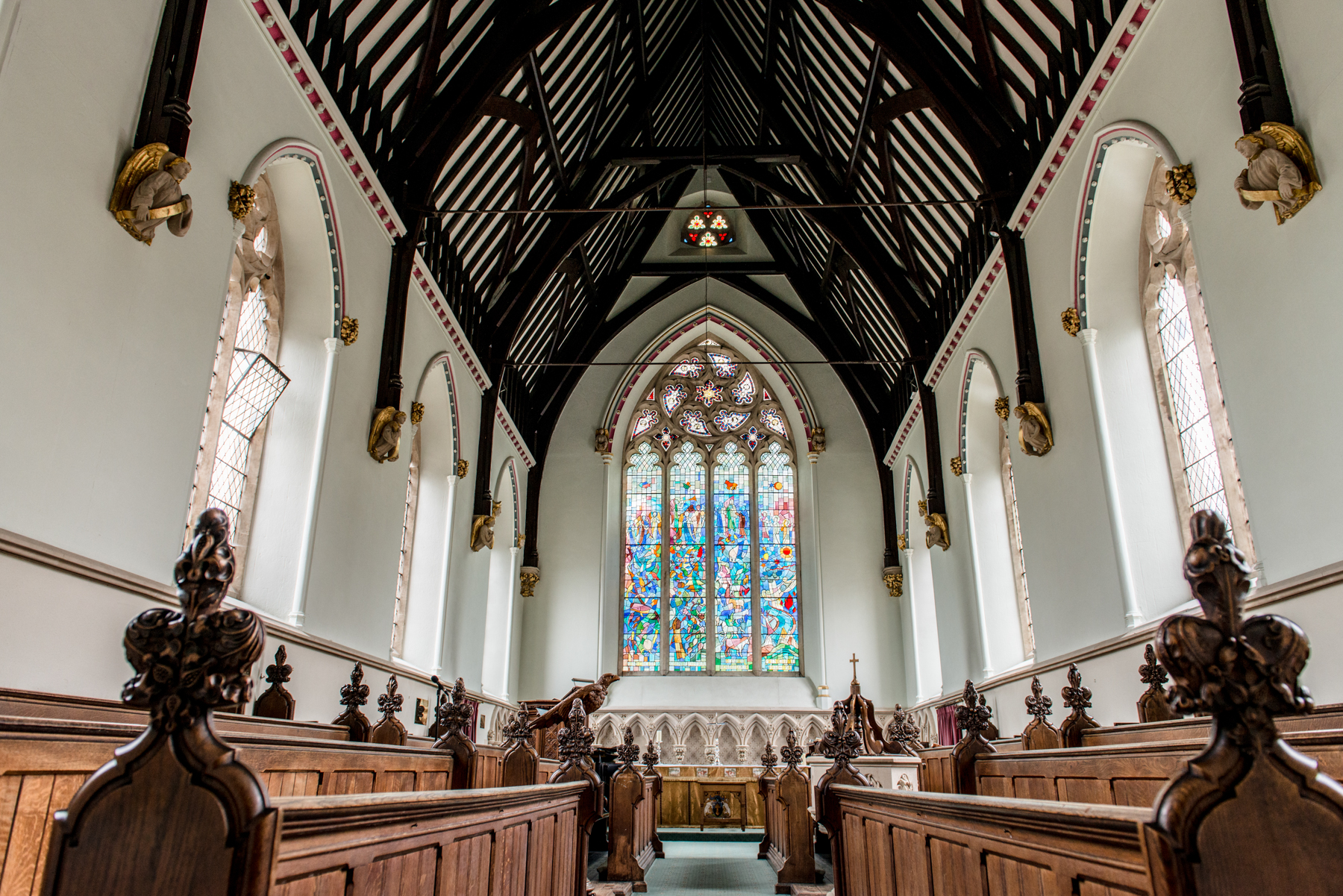 Elegant venue with vaulted ceilings and stained glass for ceremonies and gatherings.