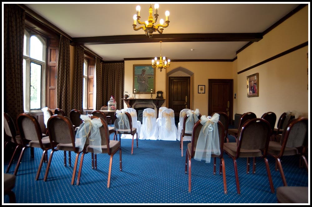 Charming wedding venue at Royal Agricultural University with elegant chair decor.