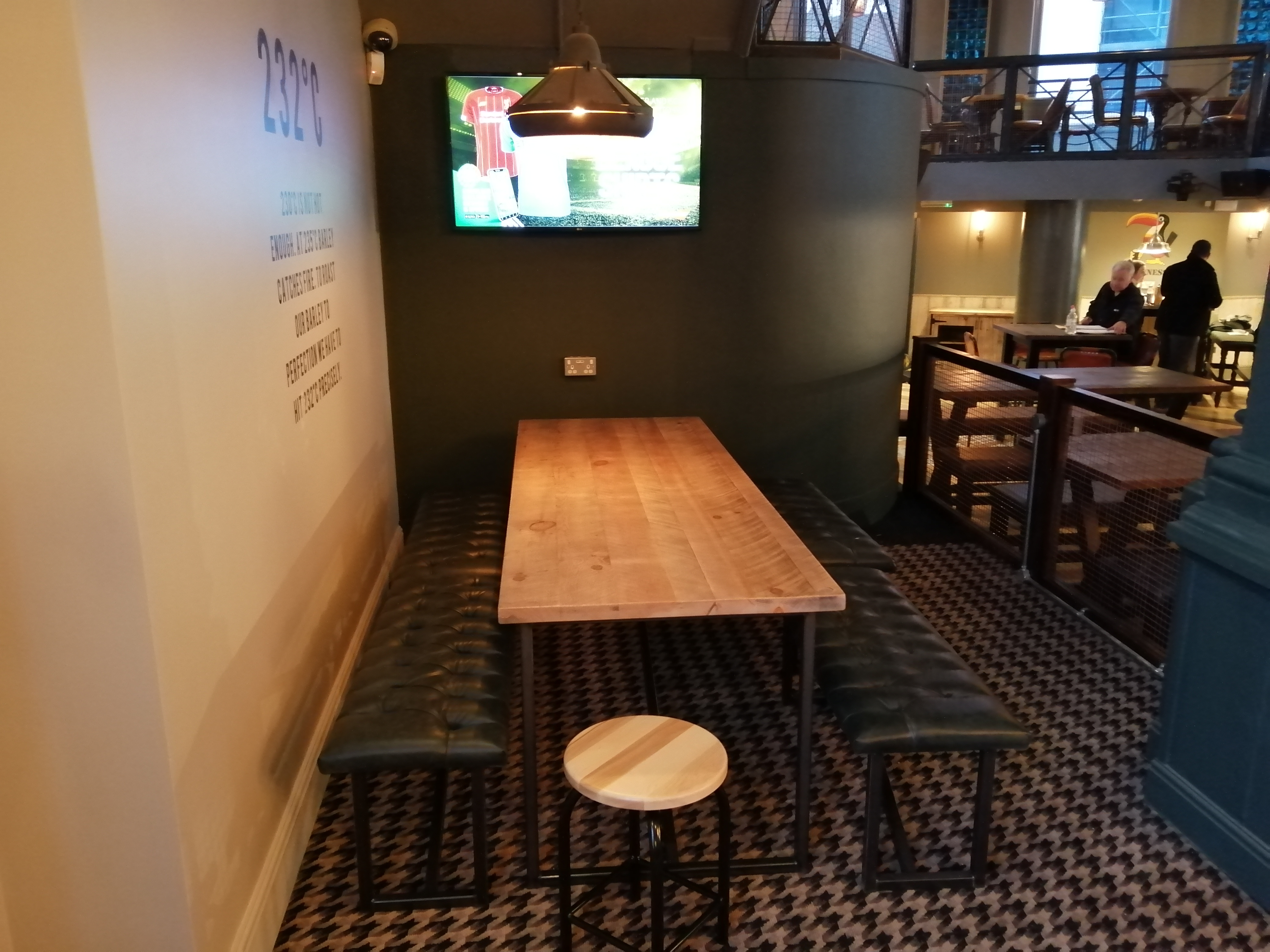 Cozy meeting space in O'Neill's Leeds with wooden table for informal gatherings.
