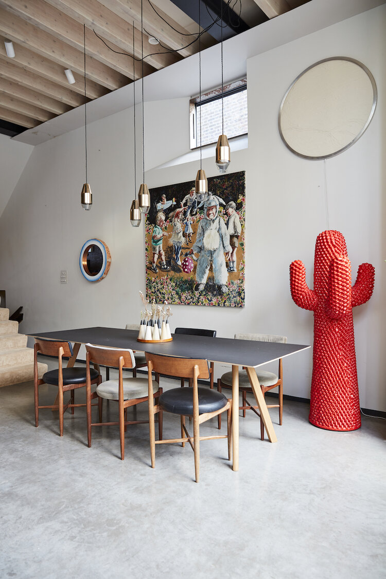 Stylish meeting space with modern table, red cactus sculpture for creative discussions.