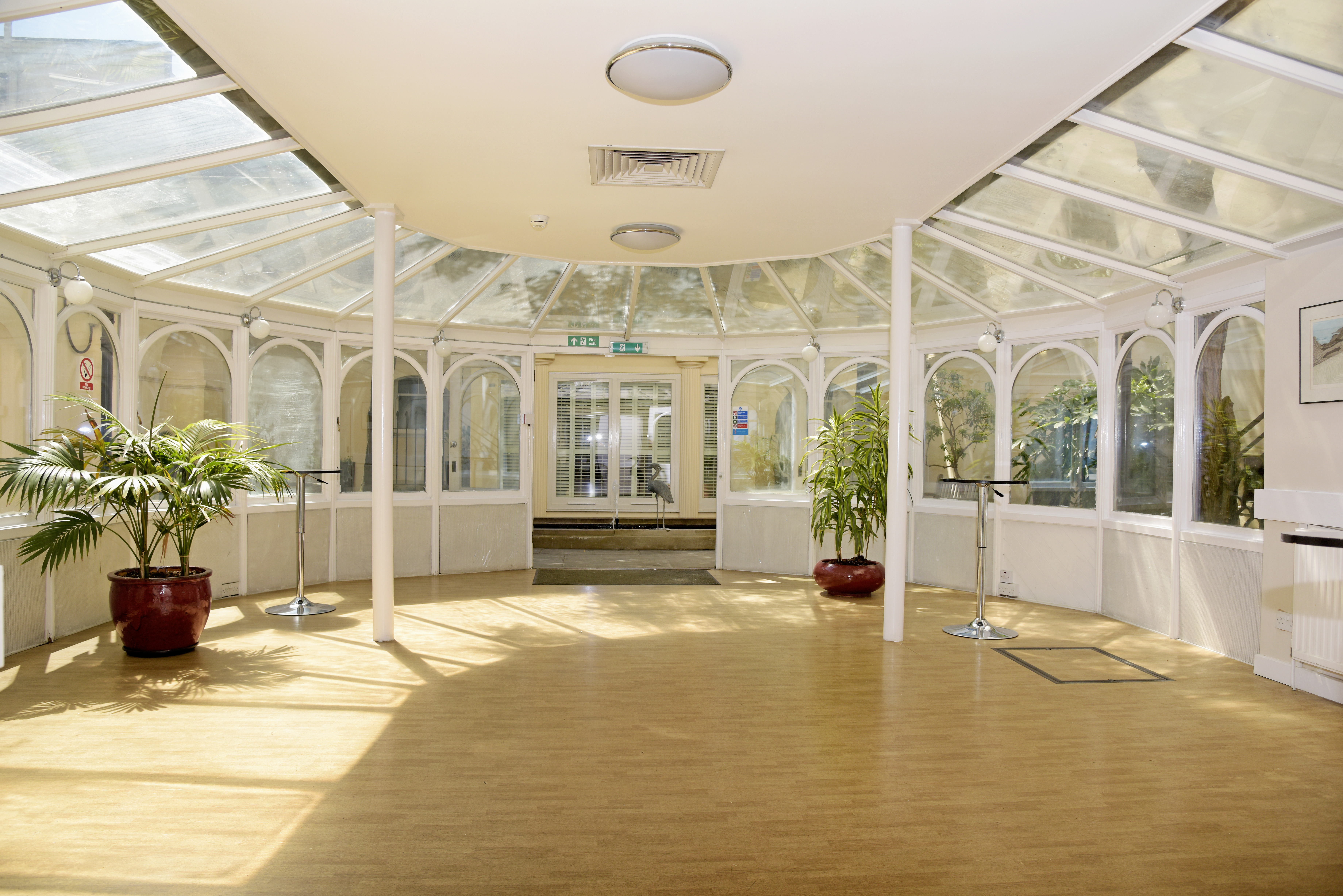 Bright Garden Room at SCI Belgravia, ideal for meetings and social gatherings.