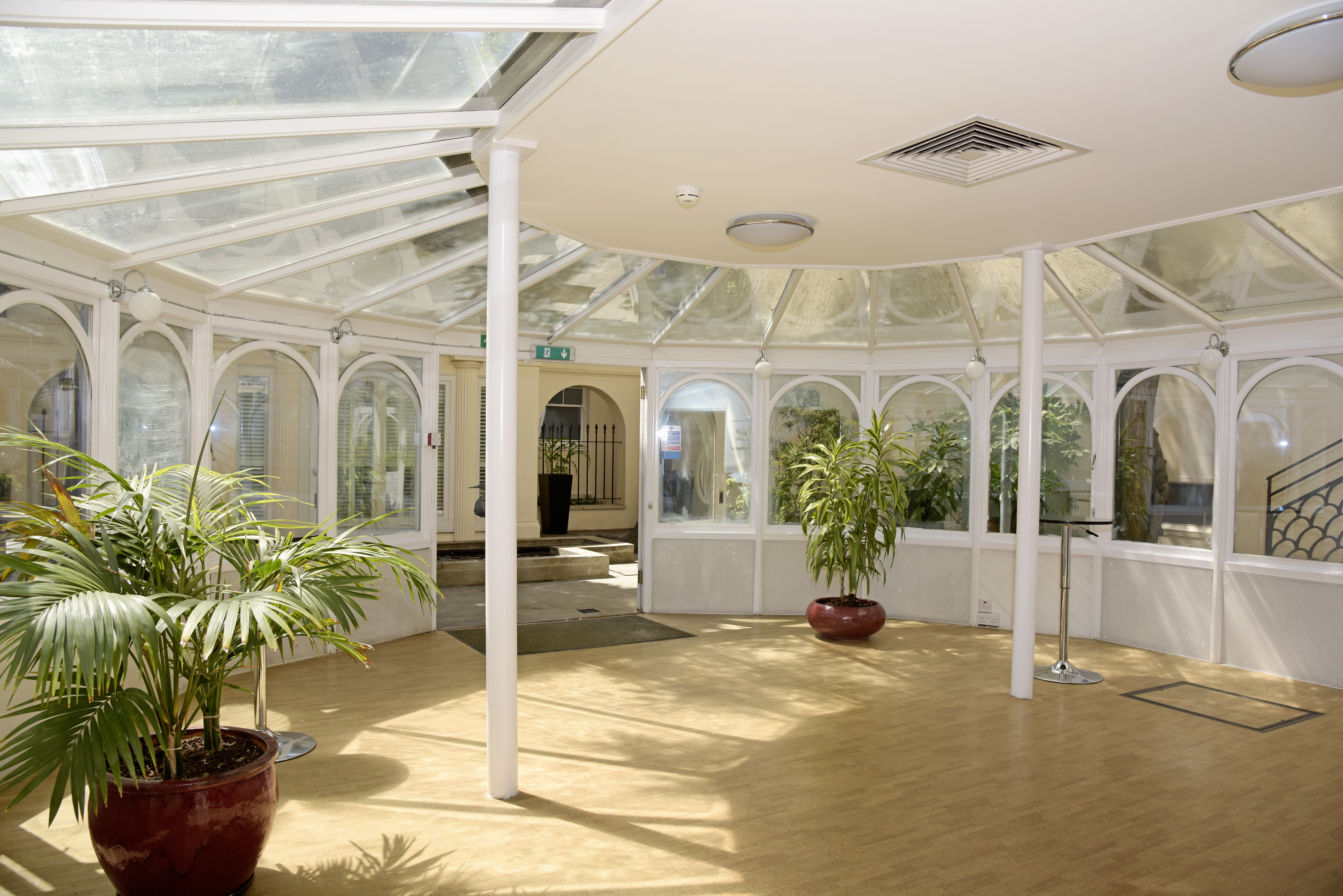 Bright Garden Room at SCI Belgravia, perfect for meetings and gatherings with natural light.