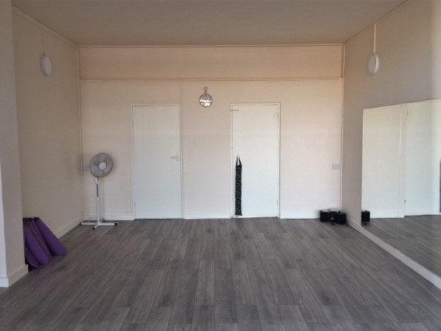 Versatile event space with yoga mats, ideal for workshops and wellness events.