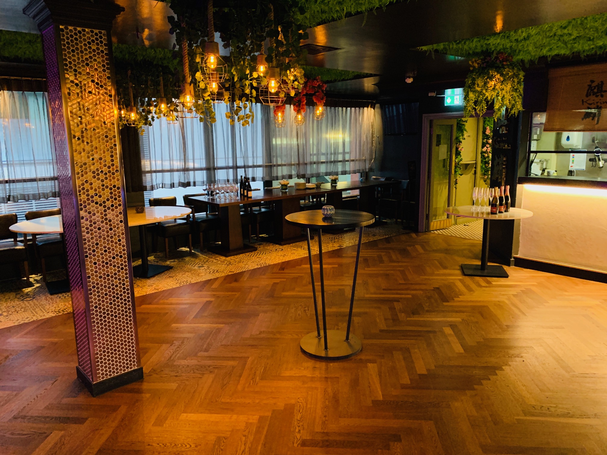 Stylish event space at Kirin Japanese Restaurant with elegant lighting and greenery.