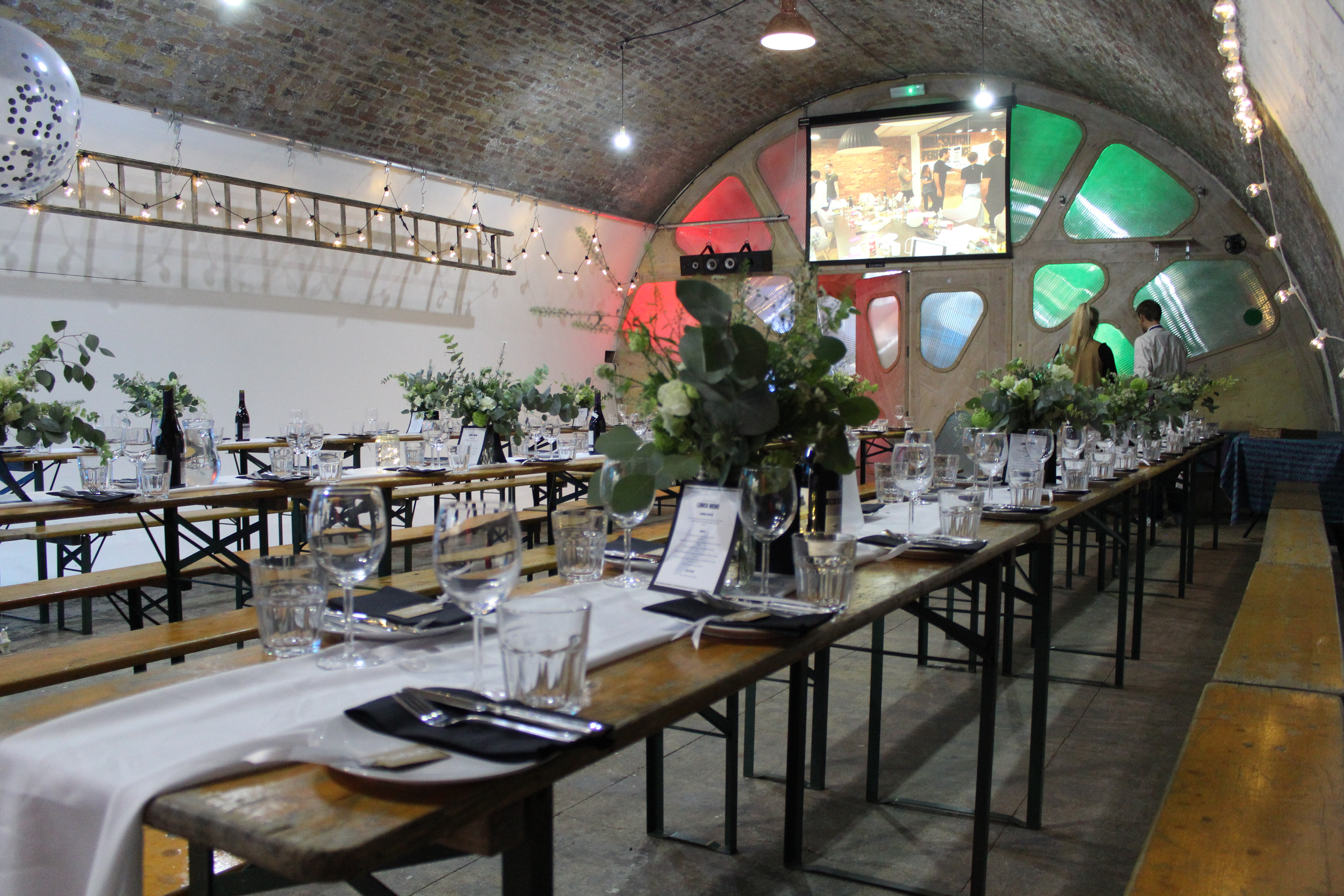 Stylish event space in Studio Z Brixton with communal tables and arched ceiling.