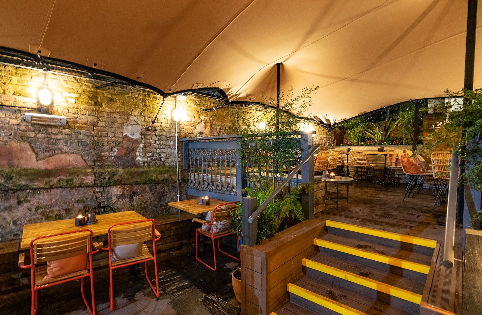 Charming outdoor event space with warm lighting for intimate gatherings and meetings.