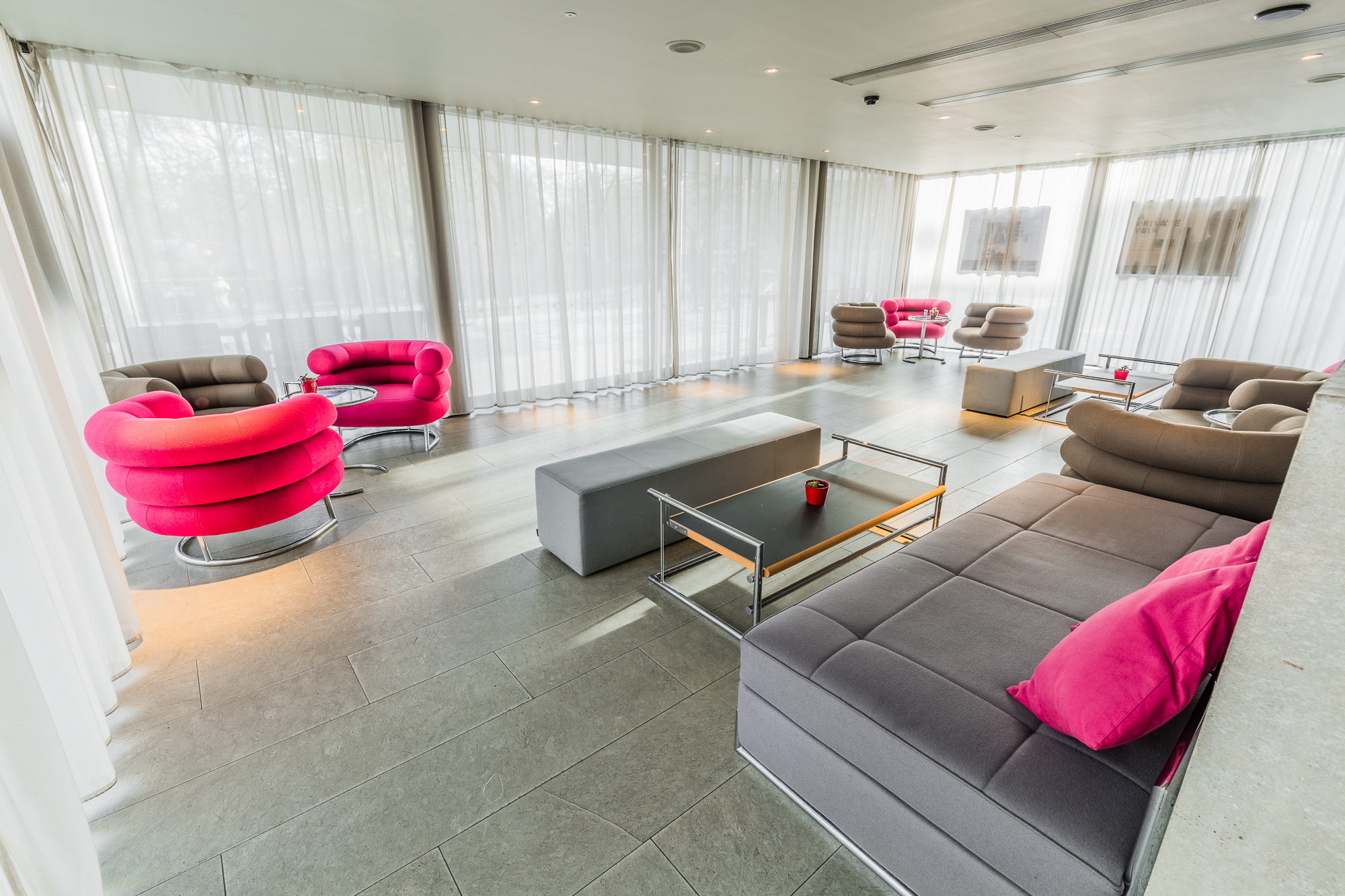 Modern lounge bar at Curzon Bloomsbury with vibrant pink accents for networking events.