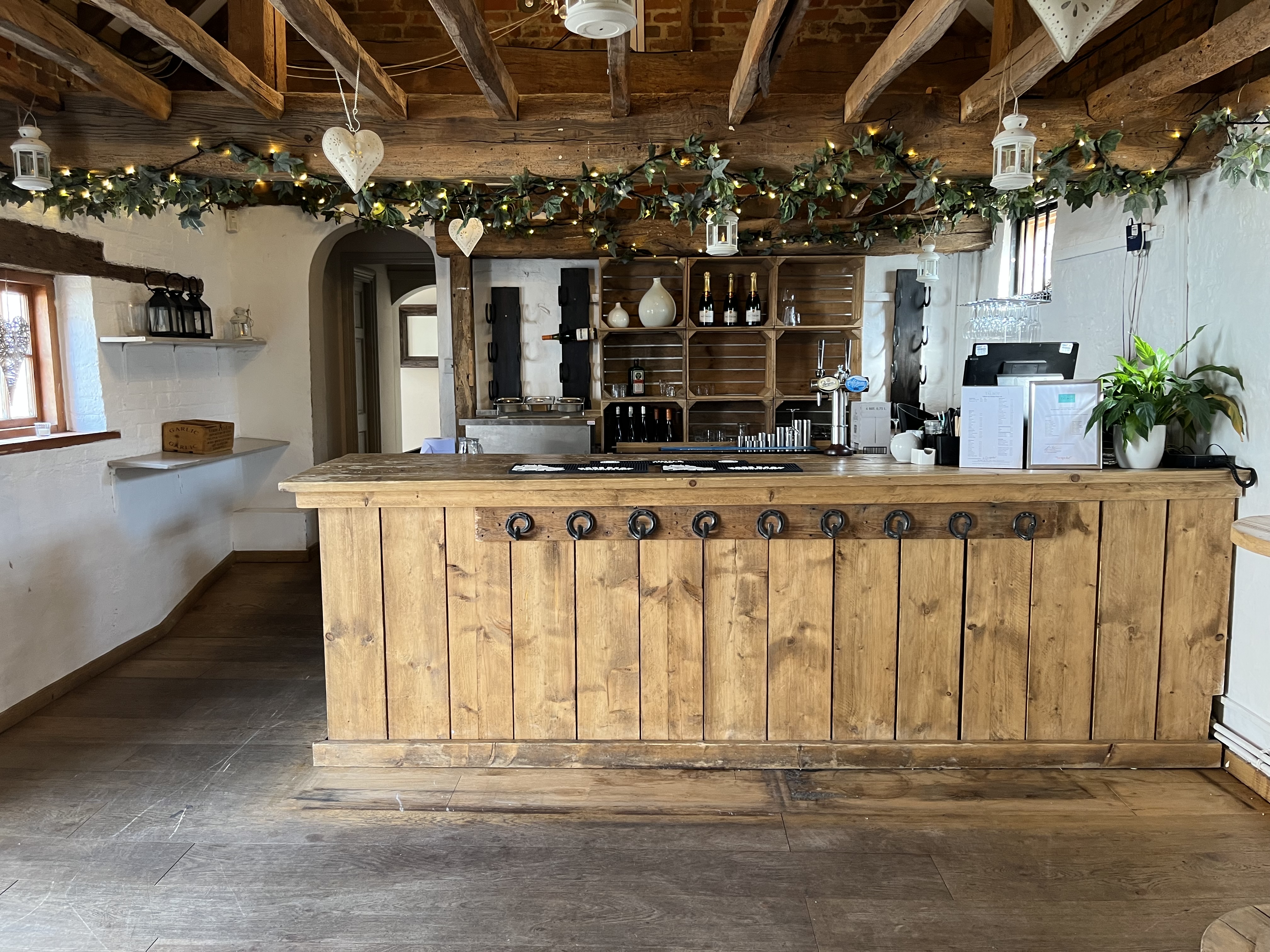 Charming reception area at The Surrey Barns, rustic bar for events and gatherings.