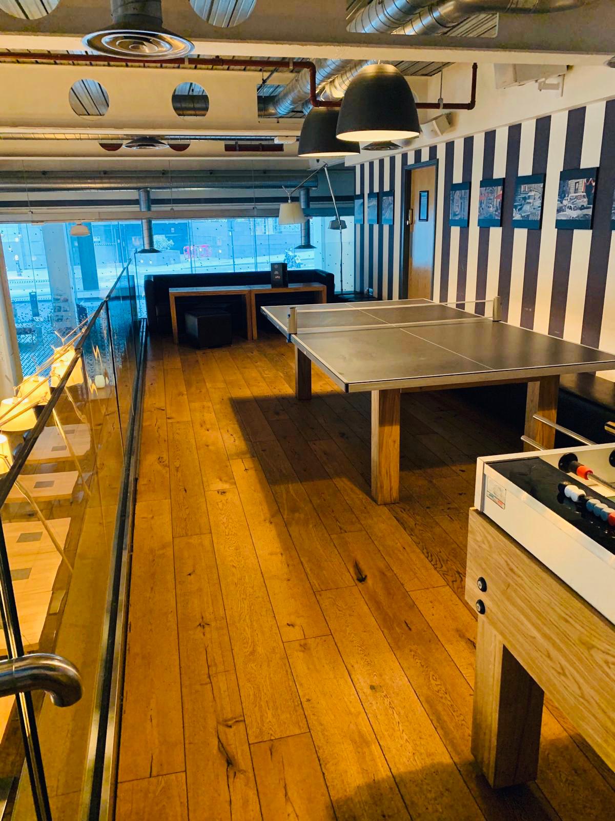 Modern event space with ping pong table, ideal for networking and team-building activities.