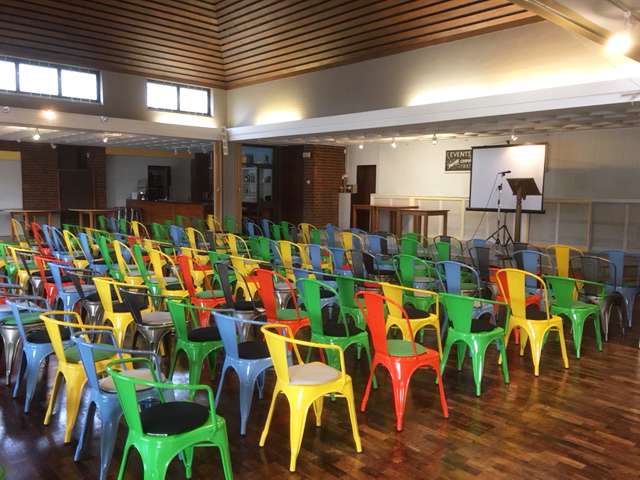 Colorful metal chairs in Guildford Cathedral for engaging workshops and presentations.