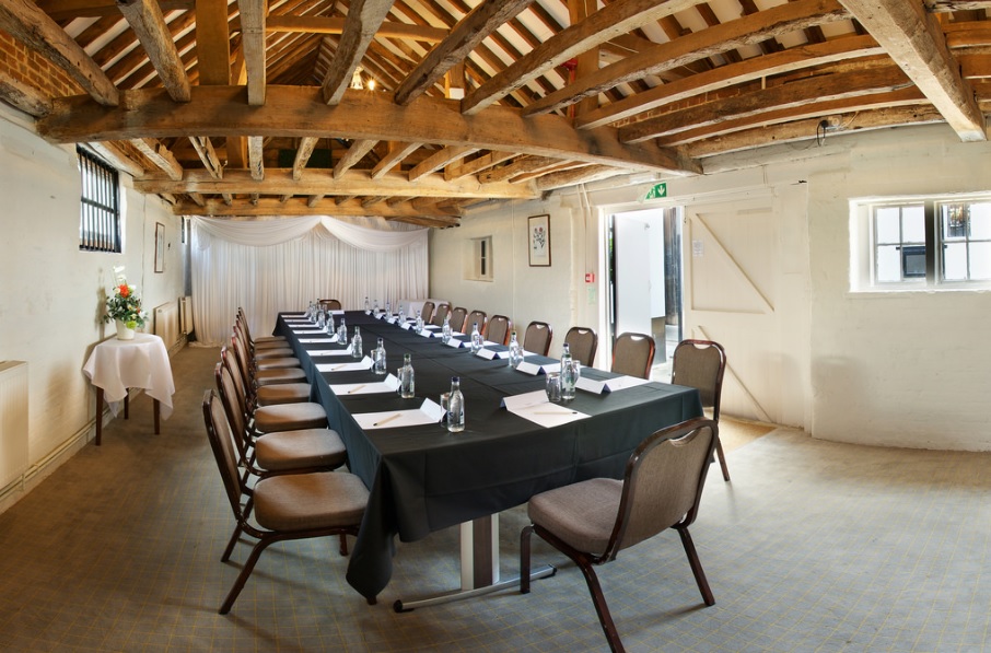 Surrey Barns meeting space with rustic beams, ideal for workshops and strategy sessions.