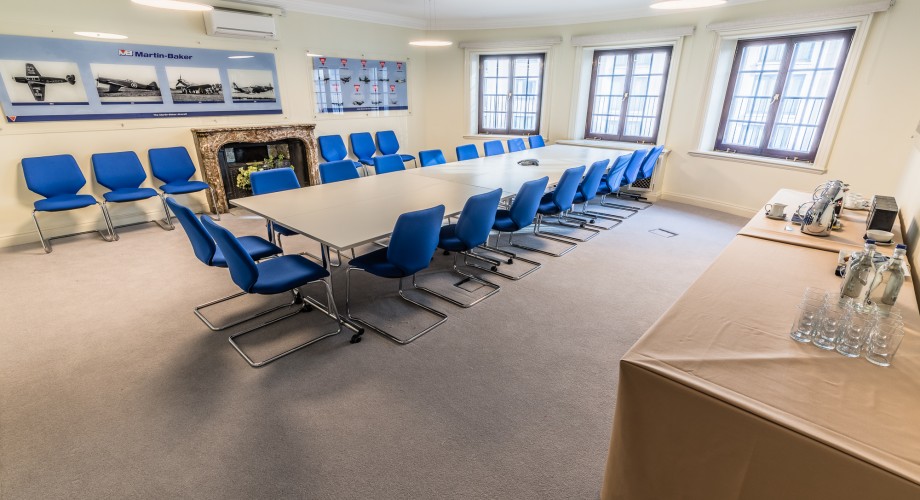 Martin-Baker Room with large table and blue chairs for efficient meetings and events.