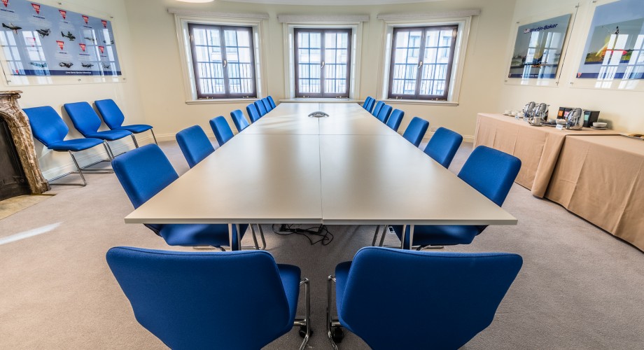 Martin-Baker Room with blue chairs, ideal for meetings and brainstorming sessions.