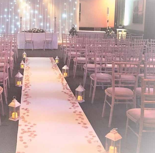 Elegant event space at Holiday Inn Guildford with floral aisle runner for weddings.