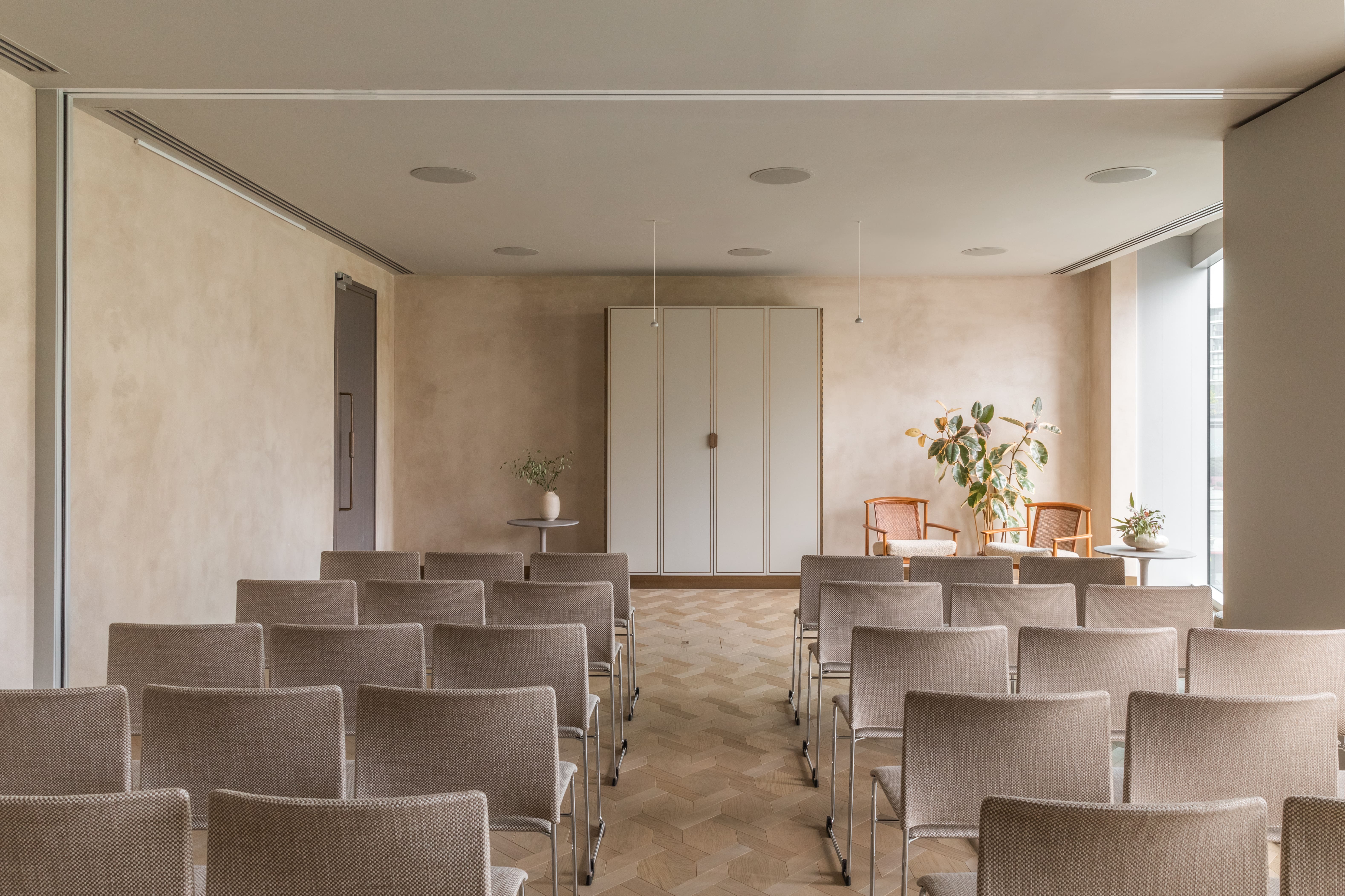 Minimalist meeting space with natural light for intimate gatherings and workshops.