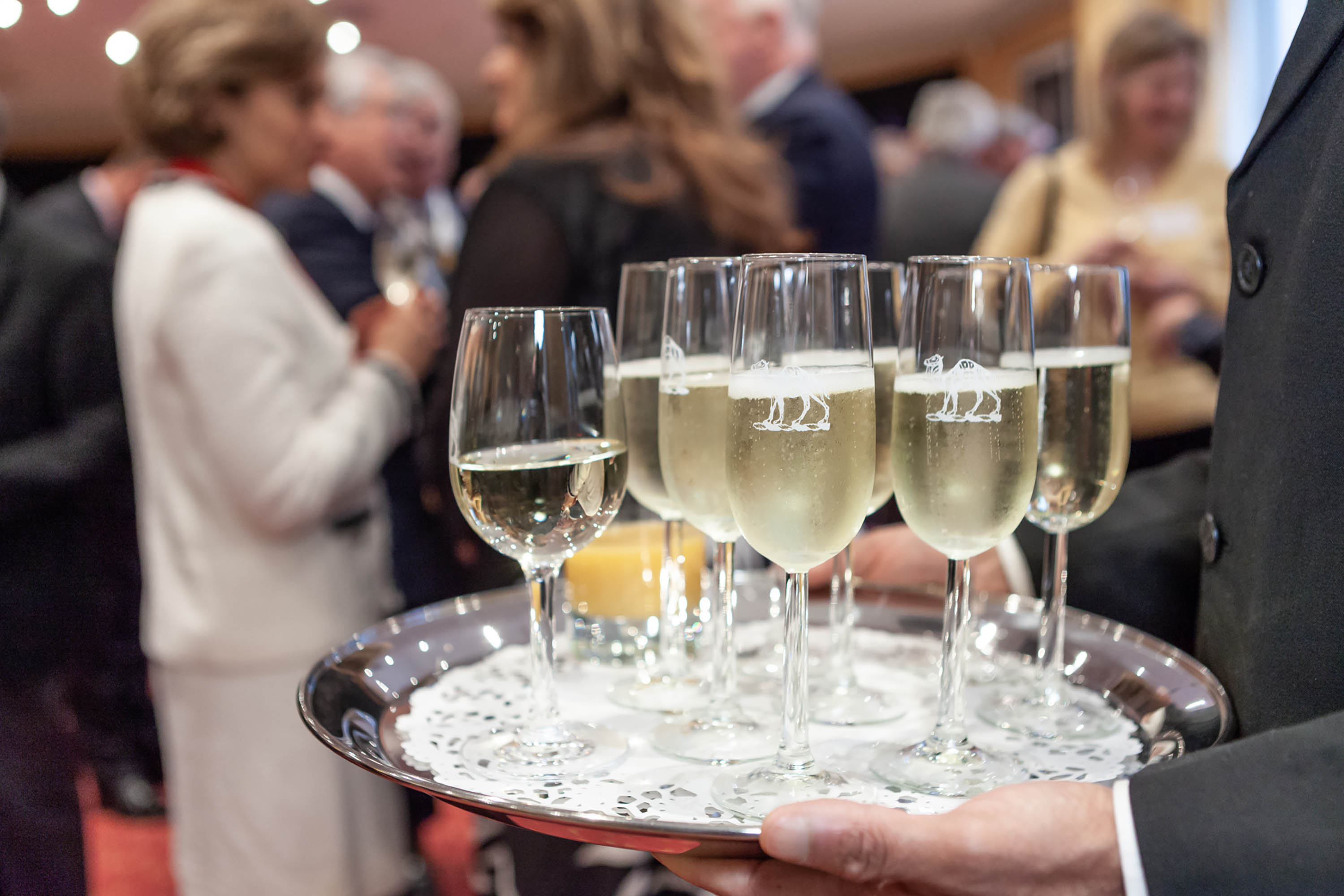 Piper Room networking event with elegant champagne flutes fostering connections.