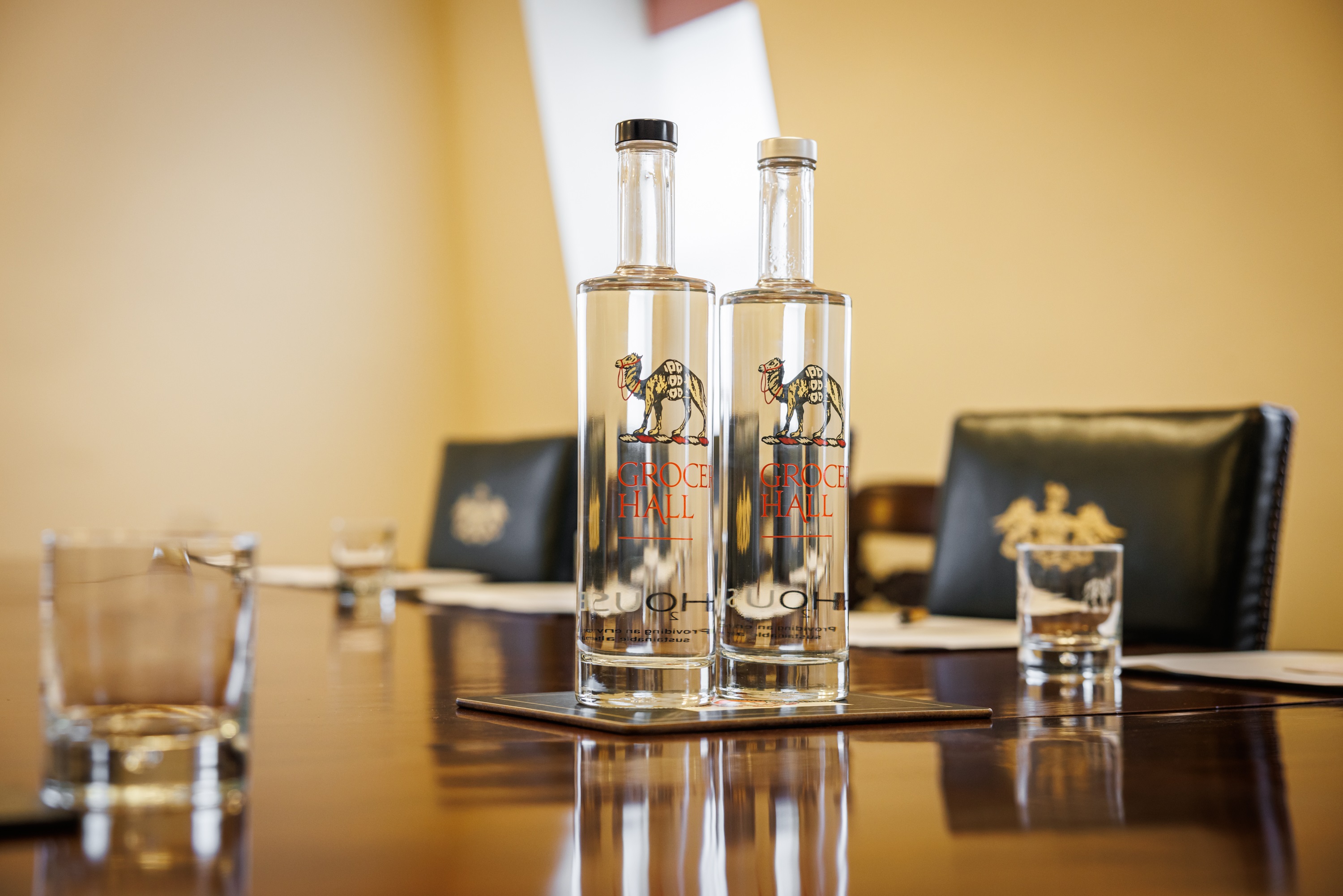 Pitt Library conference table set for a meeting with elegant glassware and water bottles.