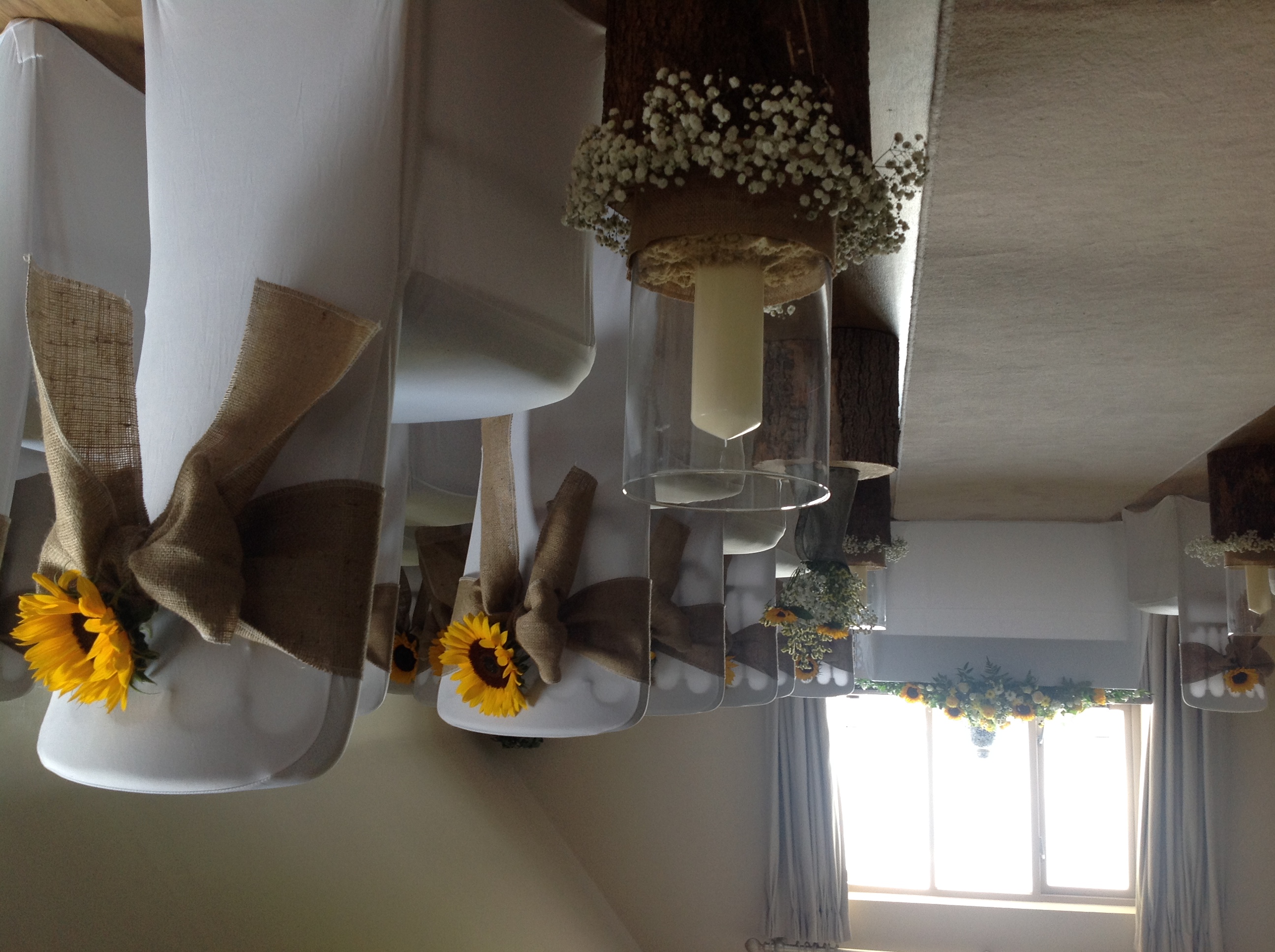 Rustic wedding ceremony at Blacknest Golf Club with burlap bows and sunflowers.