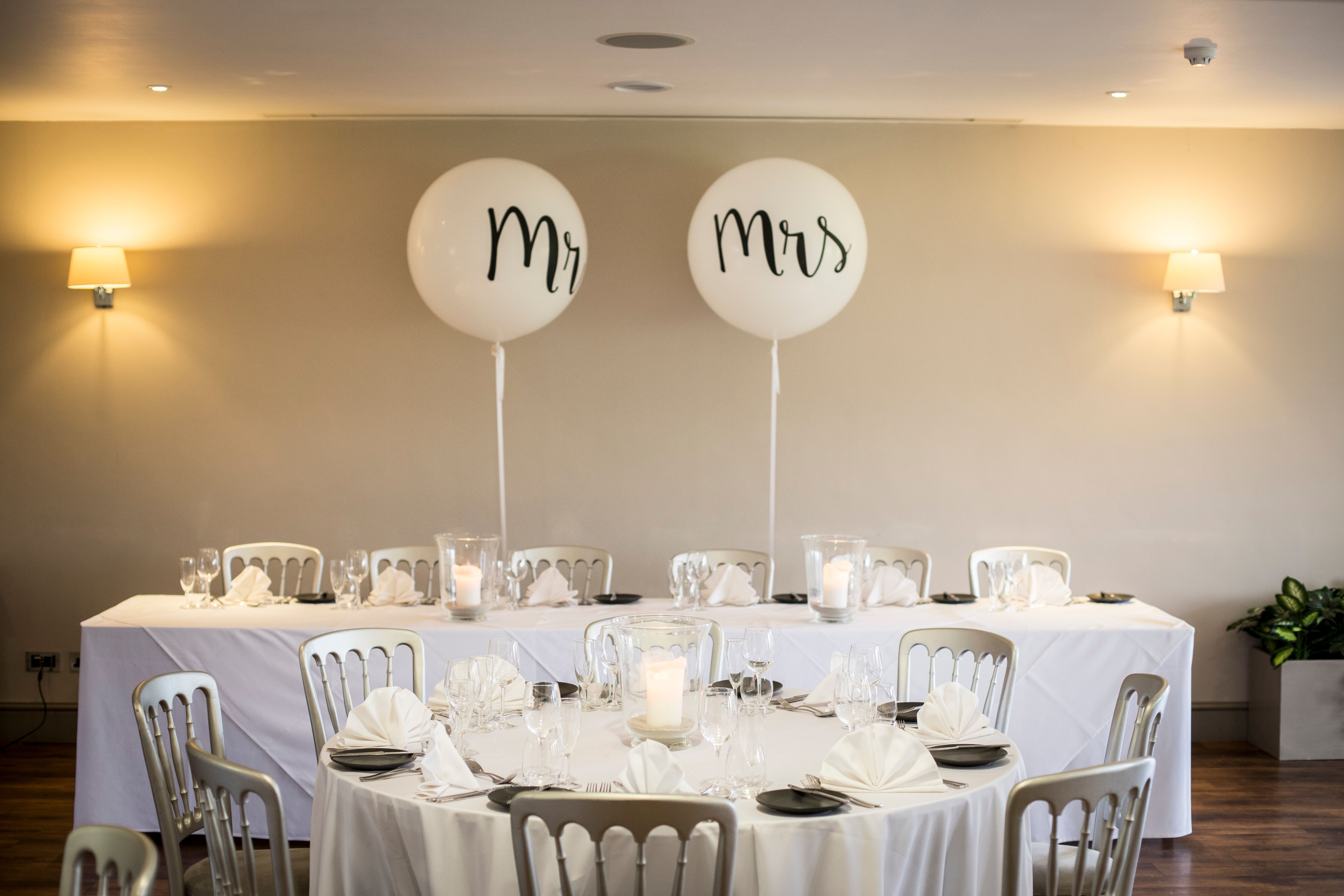 Elegant wedding reception table at Blacknest Golf Club with "Mr" and "Mrs" balloons.