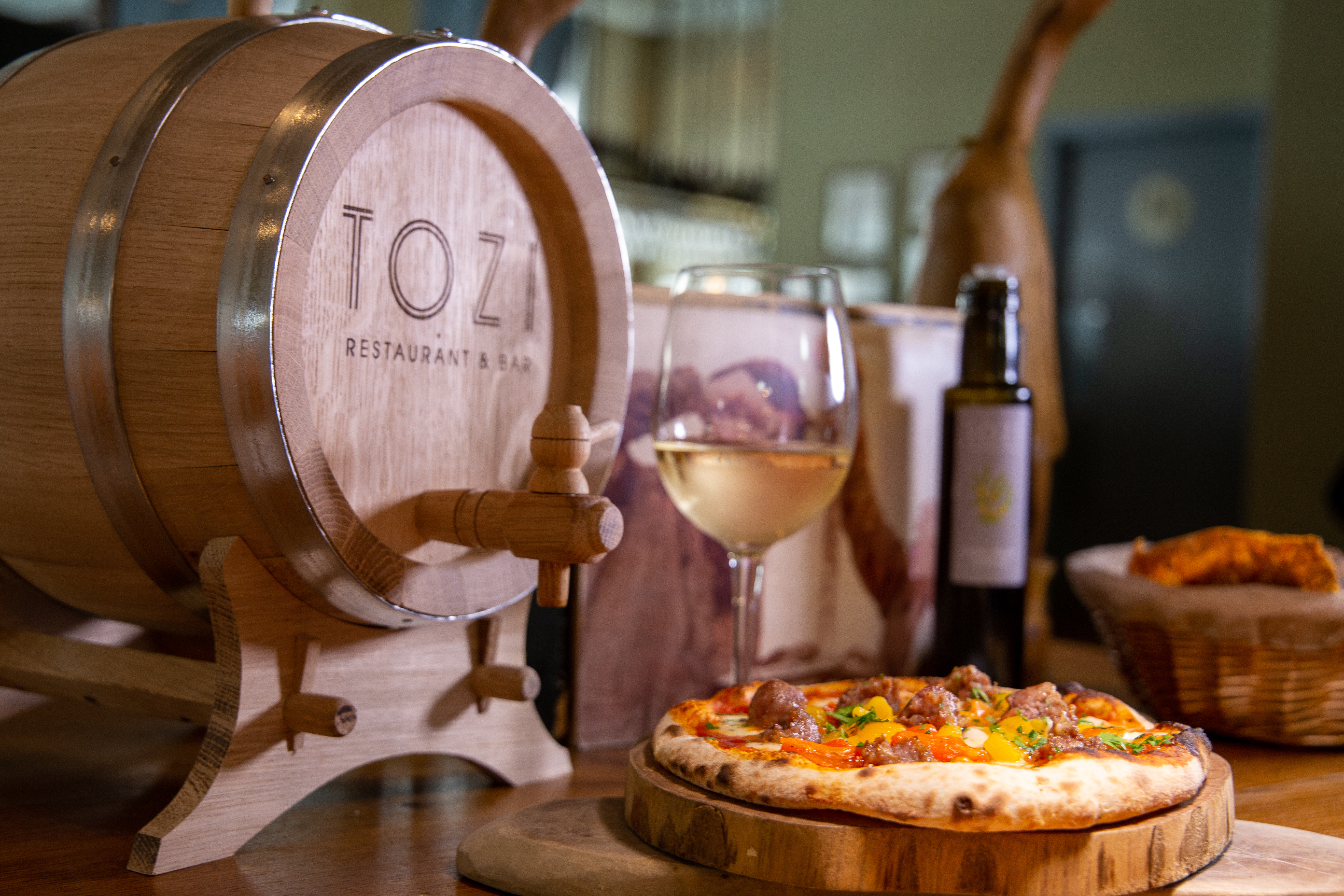 Semi-private dining room at TOZI with rustic barrel, ideal for culinary events and gatherings.