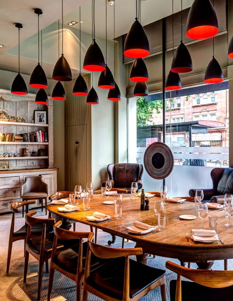 Semi-private dining room with round table, ideal for corporate meetings and gatherings.