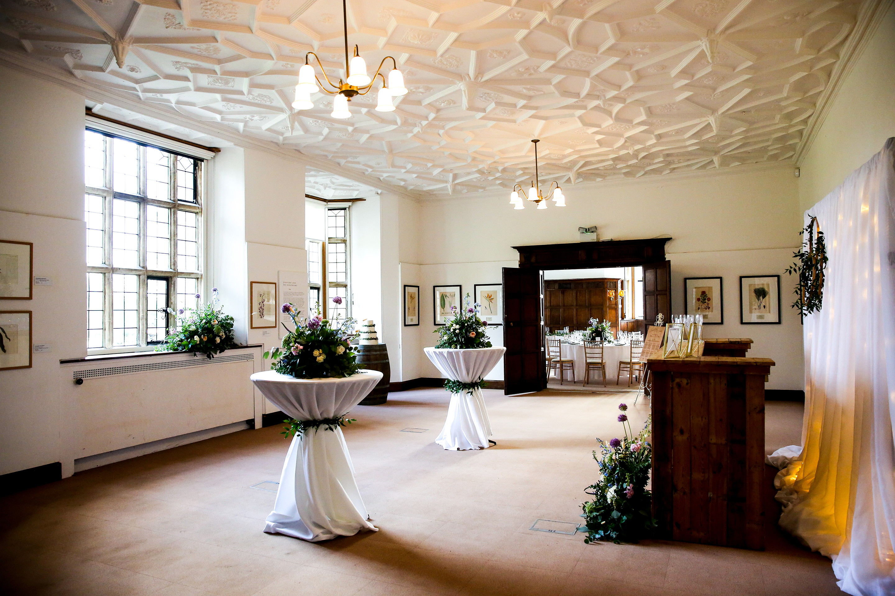Elegant Mansion Gallery event space with floral decor, ideal for weddings and receptions.
