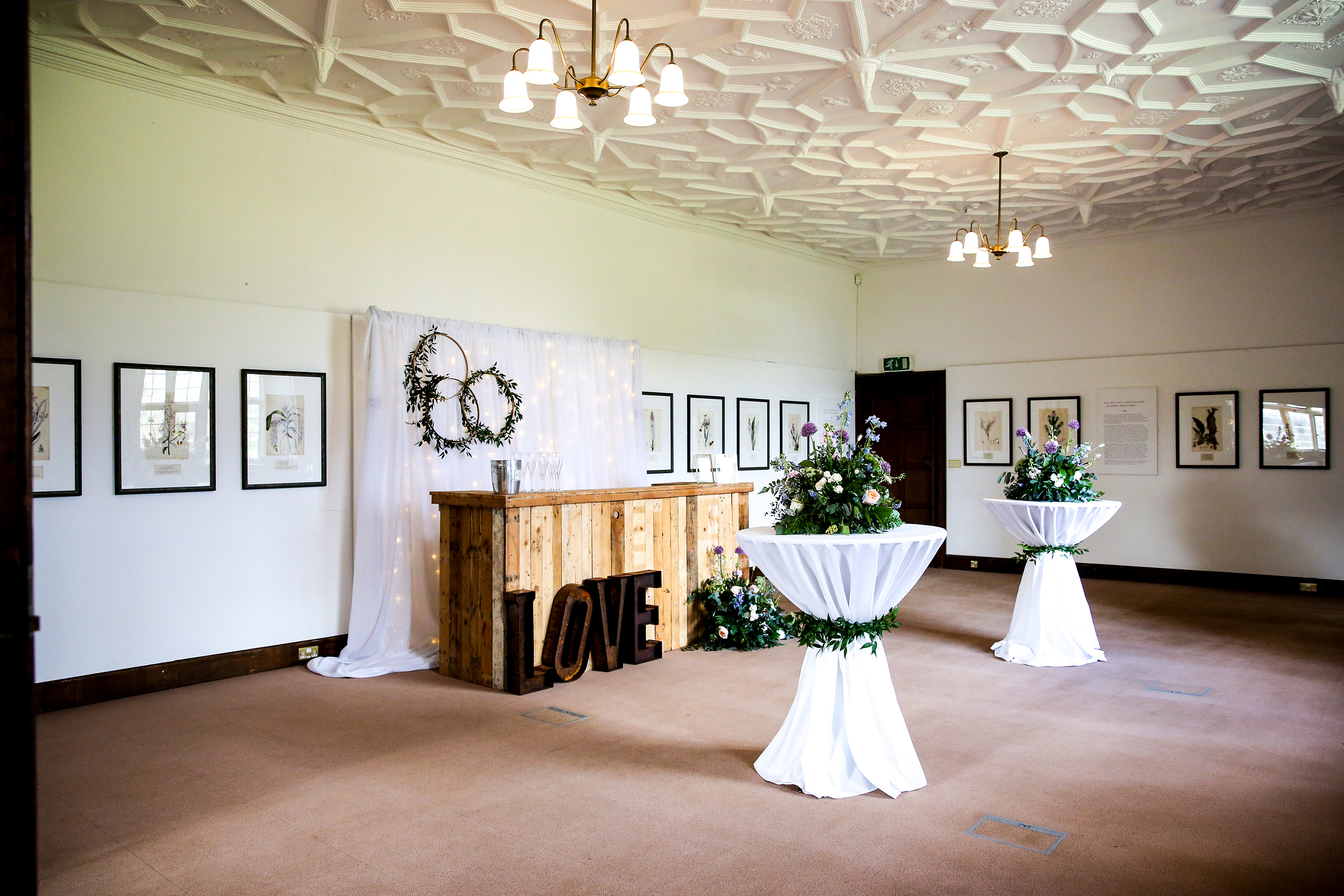 Mansion Gallery event space with rustic bar, ideal for weddings and gatherings.