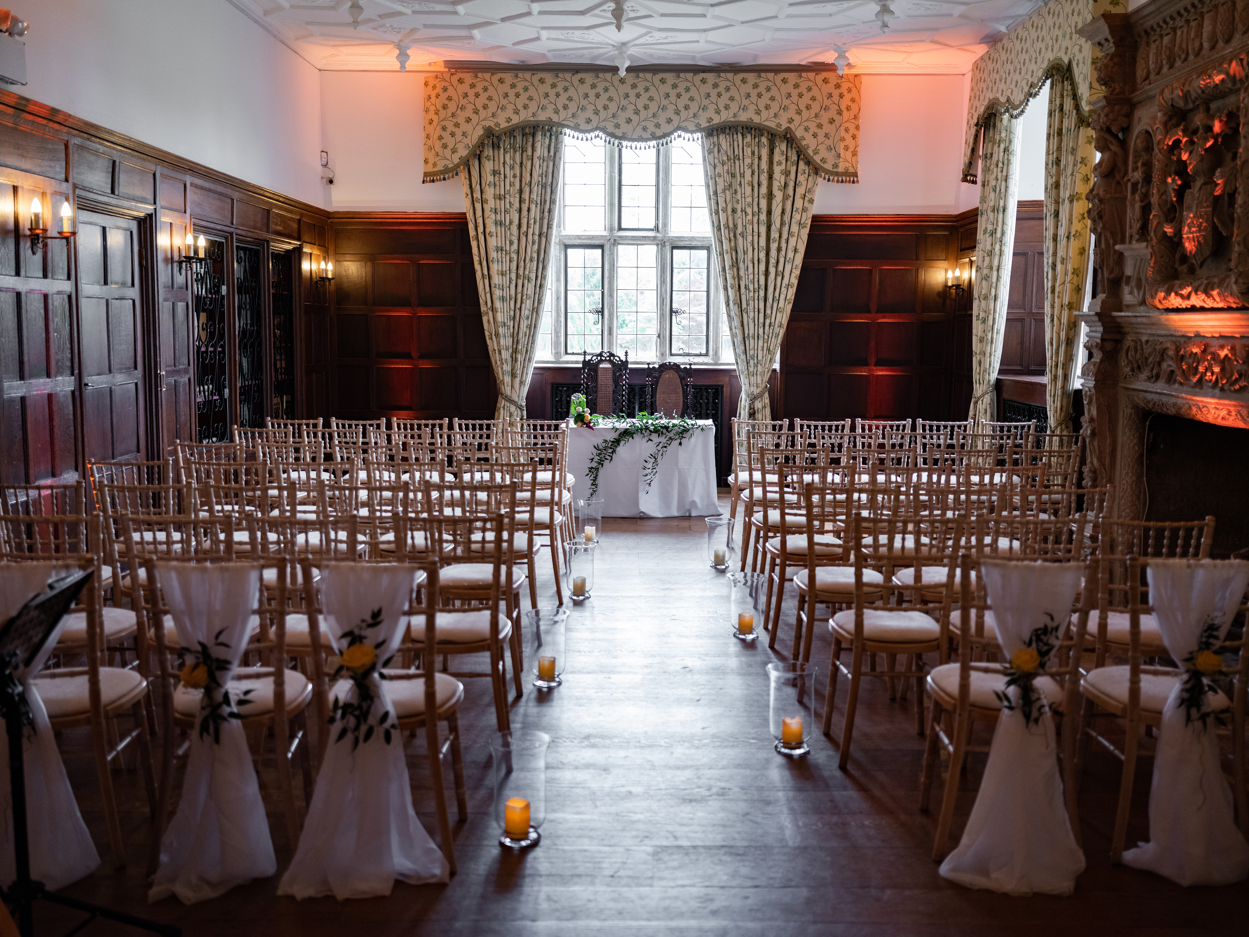 Elegant wedding venue with chiavari chairs and soft lighting at Wakehurst Library.