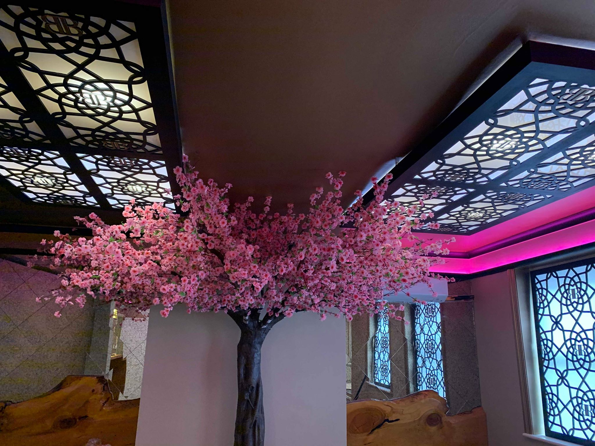 Floral cherry blossom tree in Bar Beyond's elegant event space for weddings and corporate functions.