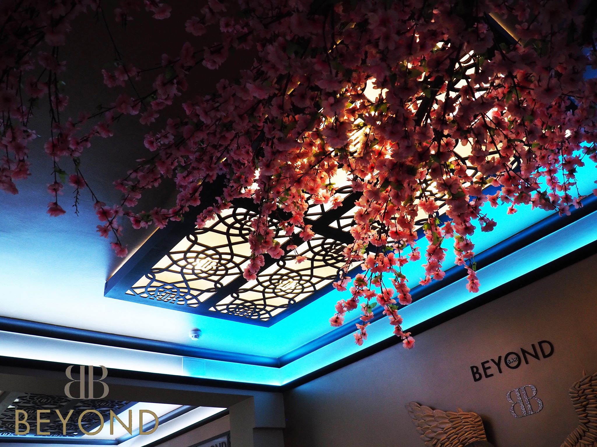Elegant event space in Bar Beyond with floral ceiling, ideal for weddings and corporate events.