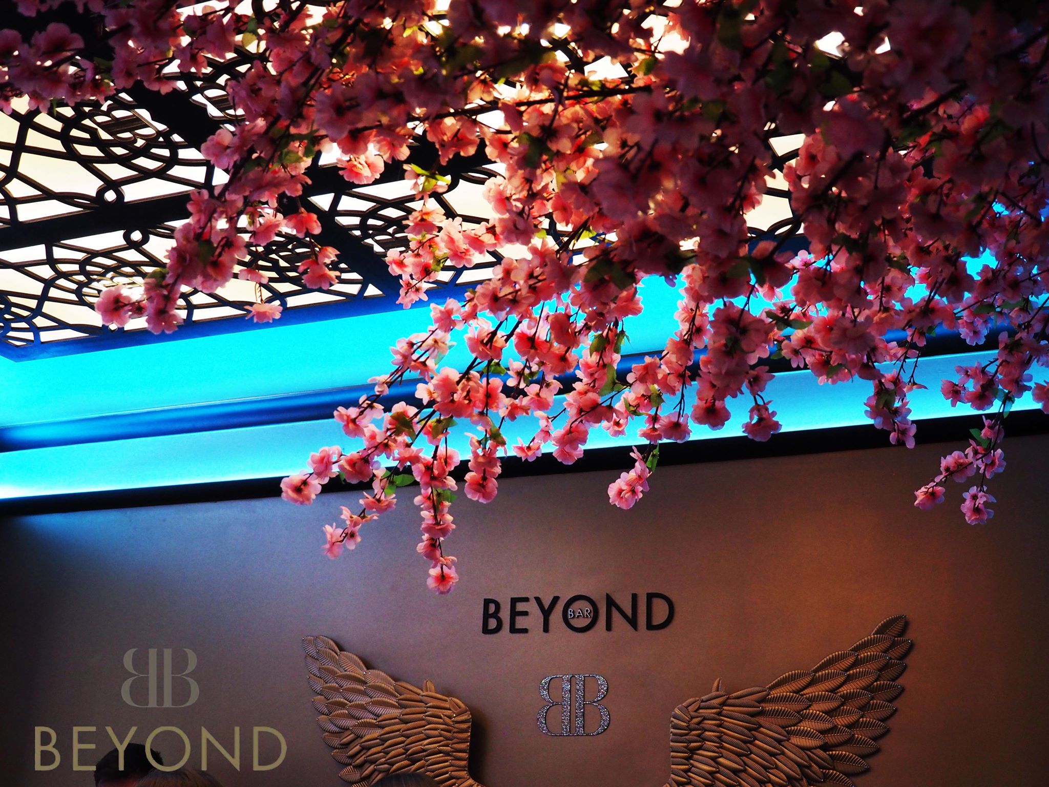 Elegant event space in Bar Beyond with cherry blossom decor, perfect for upscale gatherings.