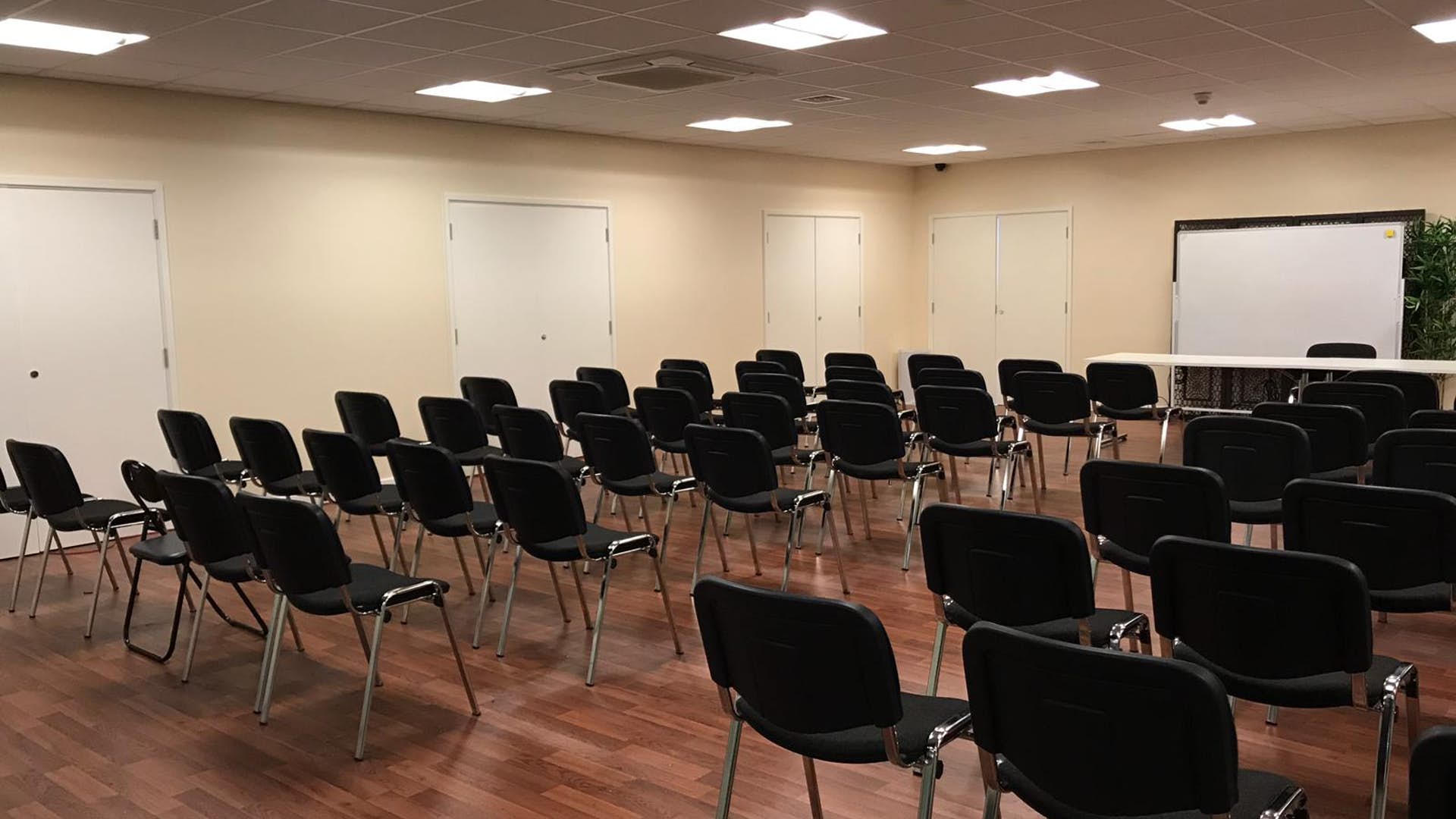 St Katherine Conference Hall with black chairs, ideal for workshops and presentations.