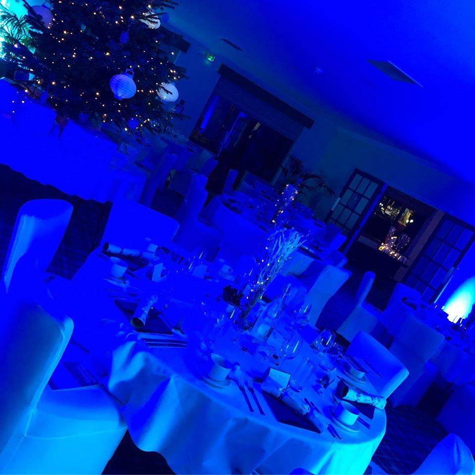 Elegant event space at Pyrford Golf Club with blue lighting for formal dinners and galas.
