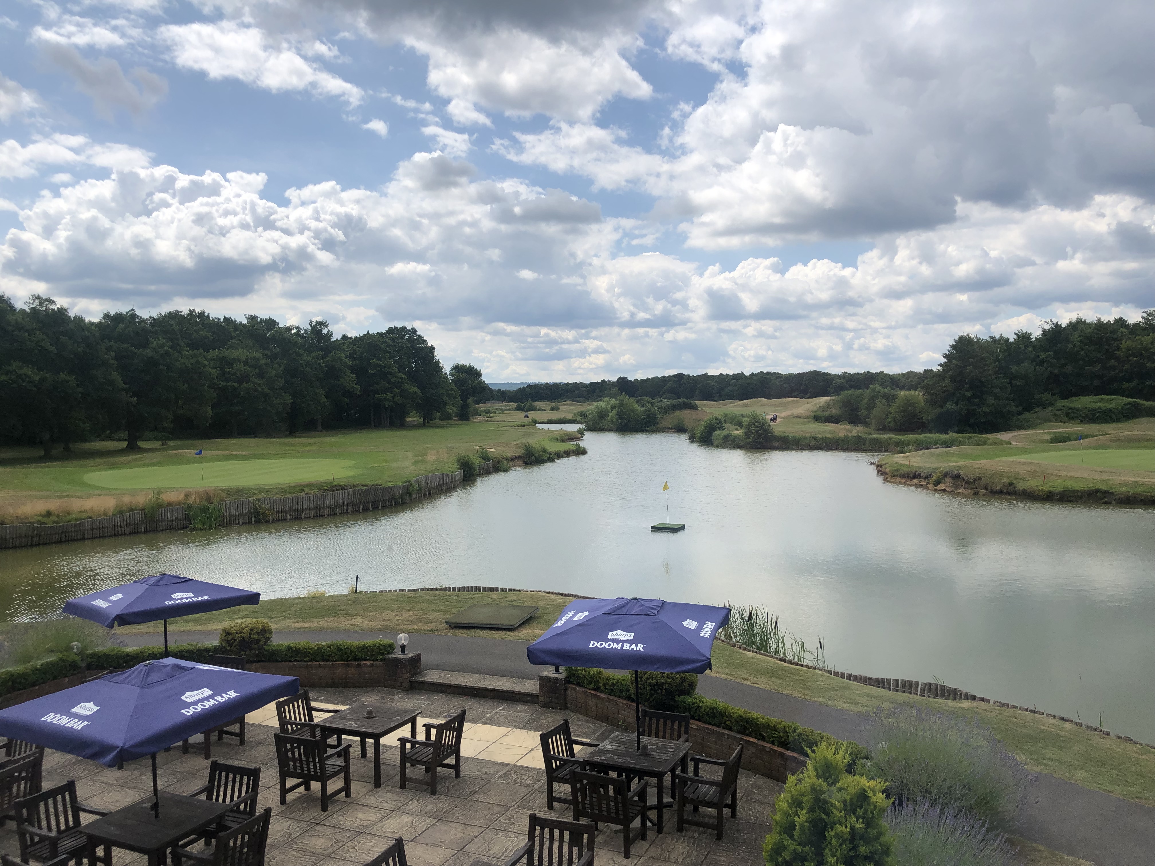 Pyrford Golf Club outdoor function room with serene lake, ideal for corporate retreats.