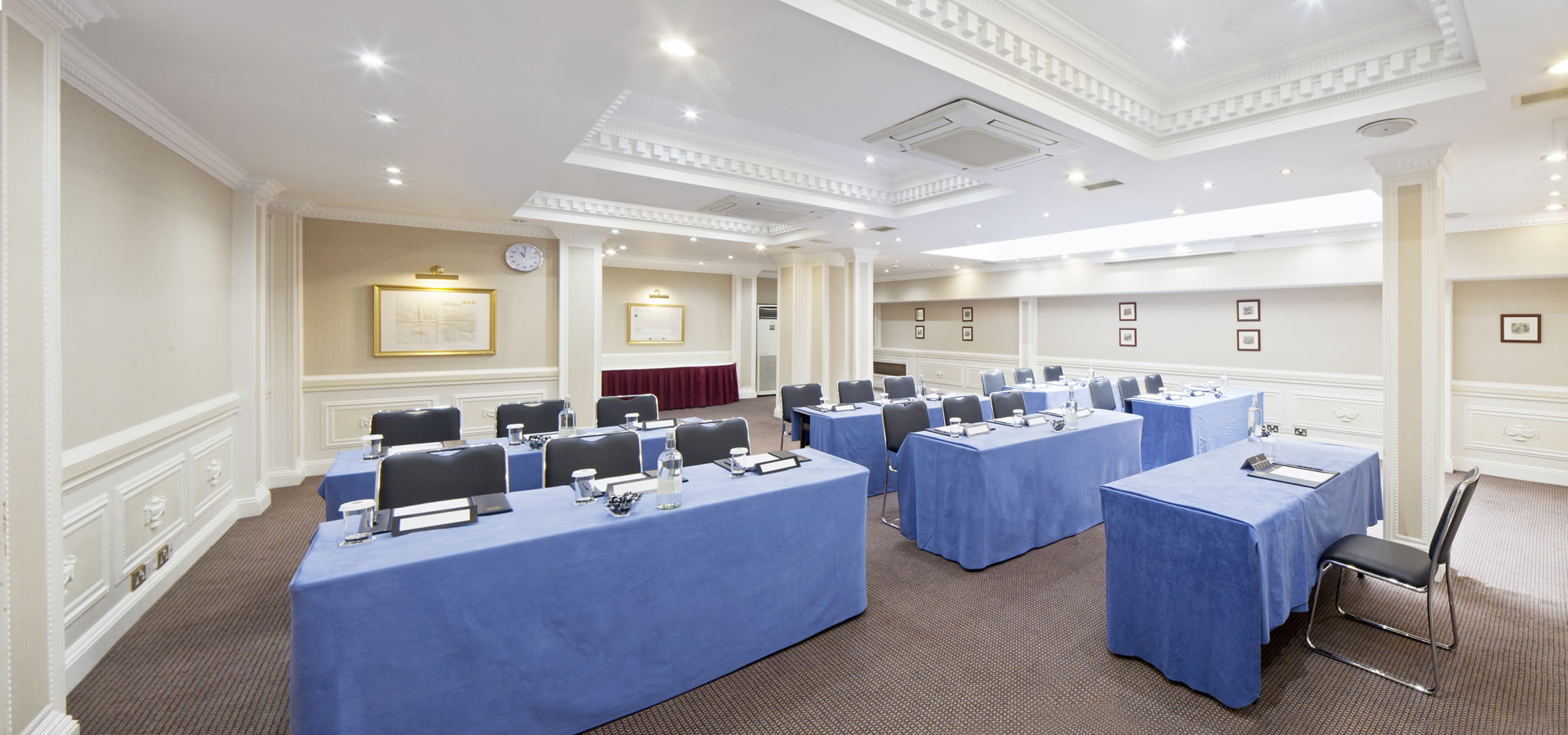Portland Suite meeting room with blue linens, ideal for professional events and workshops.