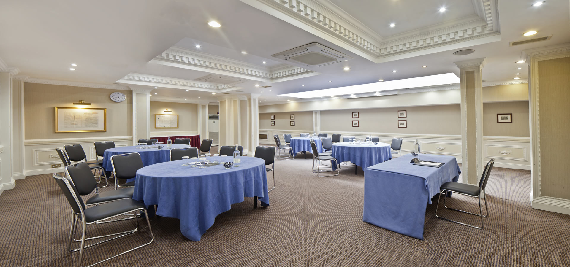 Portland Suite at Fitzrovia Hotel: versatile meeting space with round tables for events.