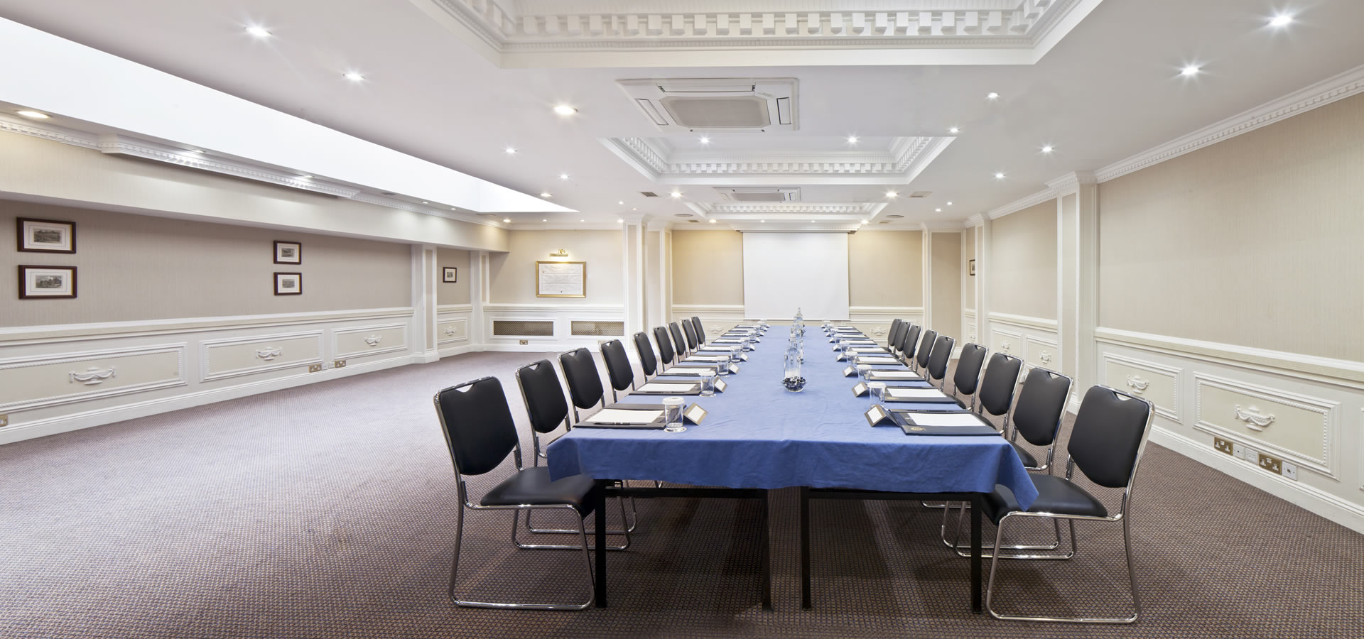 Portland Suite meeting room with blue tablecloth, ideal for corporate events and presentations.