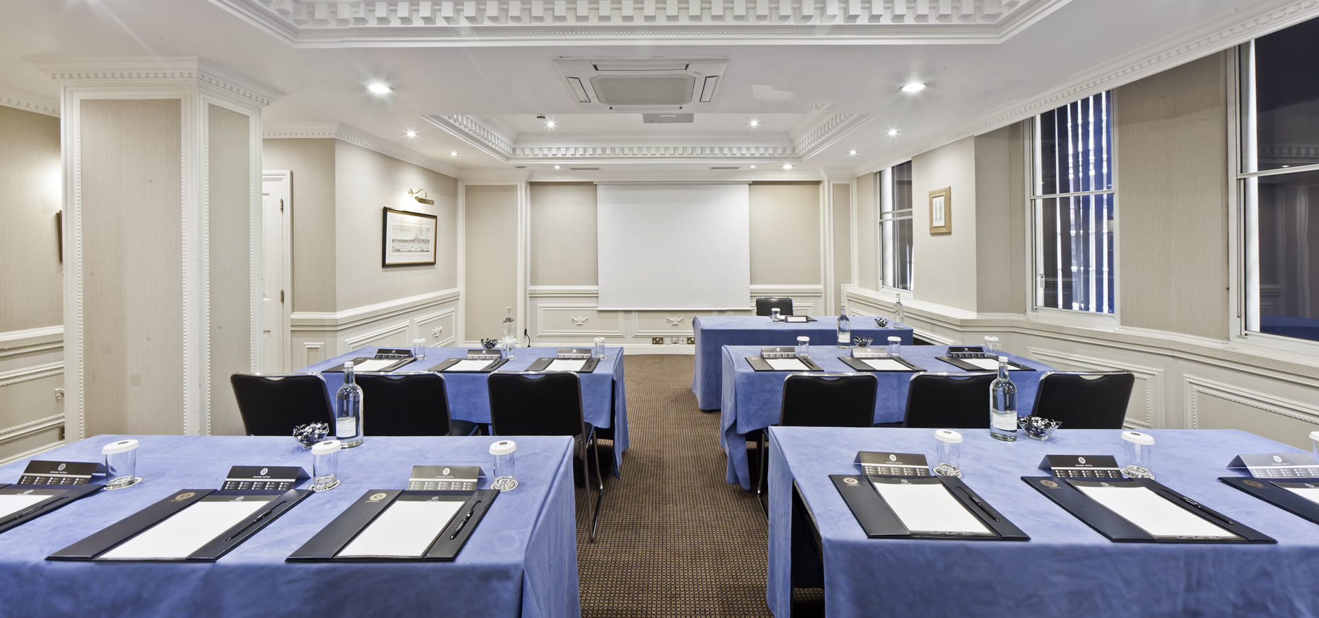 Cavendish Suite meeting room with blue tablecloths, ideal for professional events and gatherings.